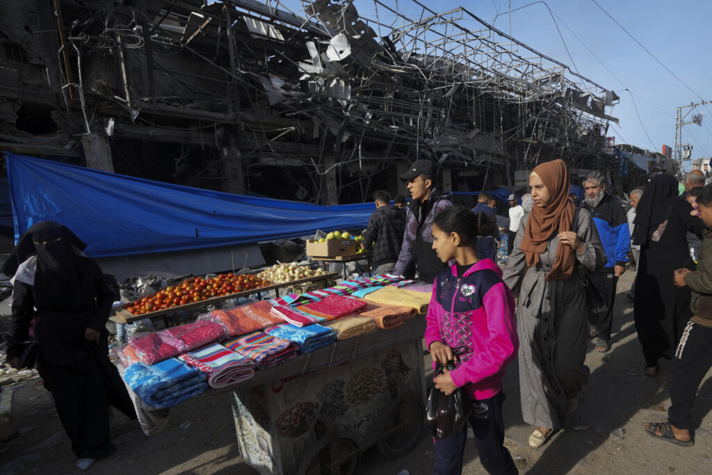 Palestinians buy vegetables and necessities in Nusseirat refugee camp, central Gaza Strip, on Saturday, Nov. 25, 2023. on the second day of the temporary ceasefire between Hamas and Israel. (AP Photo/Adel Hana)