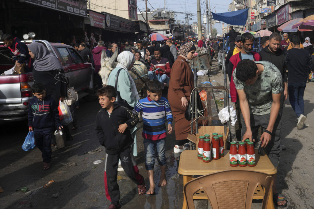 Palestinians visit an open-air market in Nusseirat refugee camp, central Gaza Strip, on Saturday, Nov. 25, 2023. on the second day of the temporary ceasefire between Hamas and Israel. (AP Photo/Adel Hana)
