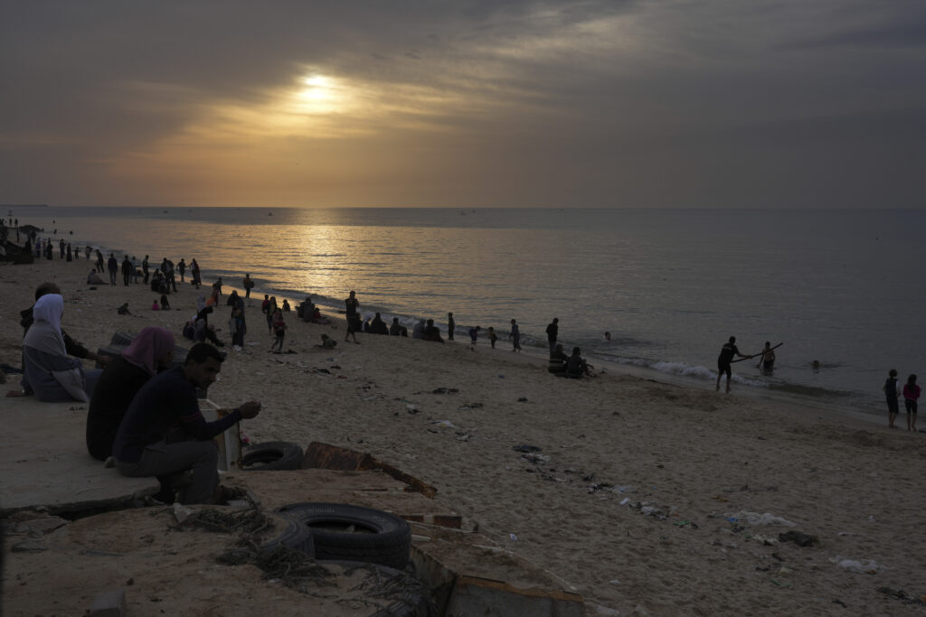 Palestinians visit the beach in Deir al Balah, Gaza Strip, on the second day of a cease-fire between Israel and Hamas, Saturday, Nov. 25, 2023. (AP Photo/Hatem Moussa)