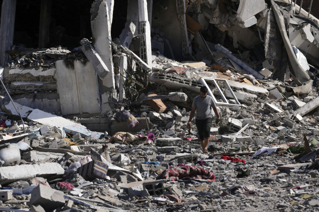 Palestinians visit their houses destroyed in the Israeli bombings in Al-Zahra, on the outskirts of Gaza City, on Thursday, Nov. 30, 2023. during the temporary ceasefire between Hamas and Israel. (AP Photo/Adel Hana)