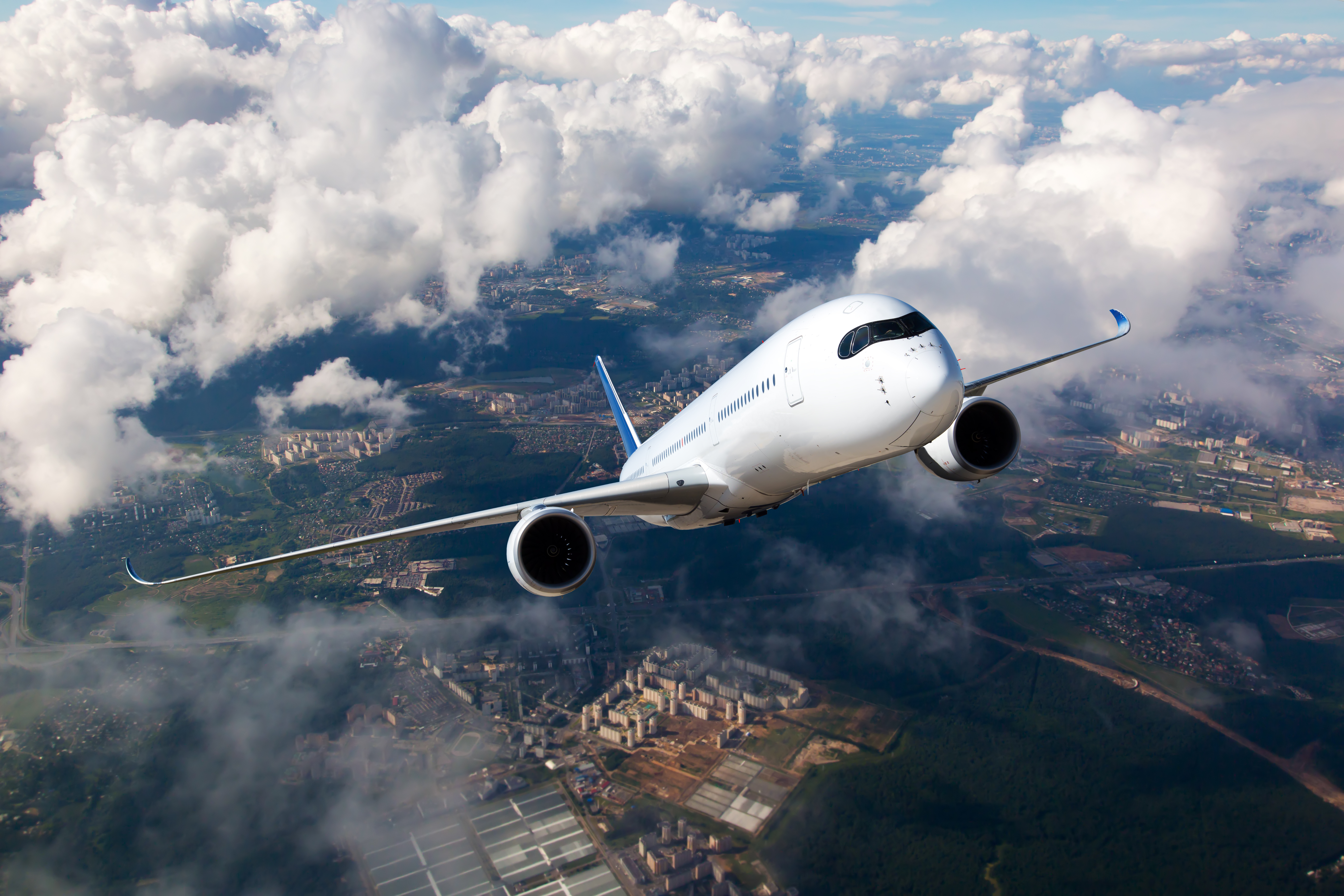 White,Passenger,Plane,Climbs,Through,The,Clouds.,Aircraft,Is,Flying