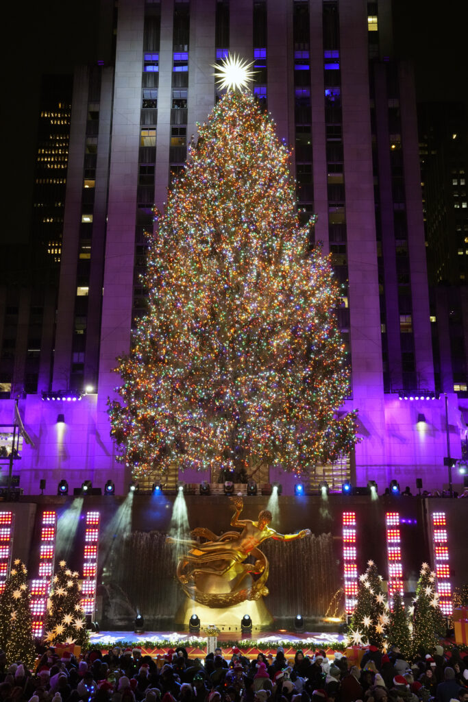 The Rockefeller Center Christmas tree is lit on Wednesday, Nov. 29, 2023, in New York. (Photo by Charles Sykes/Invision/AP)