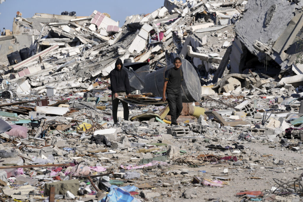 Palestinians visit their houses destroyed in the Israeli bombings in Al-Zahra, on the outskirts of Gaza City, on Thursday, Nov. 30, 2023. during the temporary ceasefire between Hamas and Israel. (AP Photo/Adel Hana)