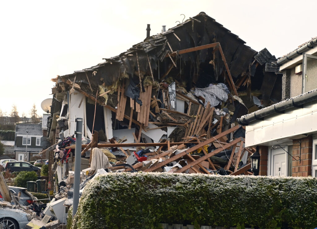 The scene on Baberton Mains Avenue, Edinburgh, after an 84-year-old man has died following an explosion at a house on Friday night, Saturday Dec. 2, 2023. (Lesley Martin/PA via AP)
