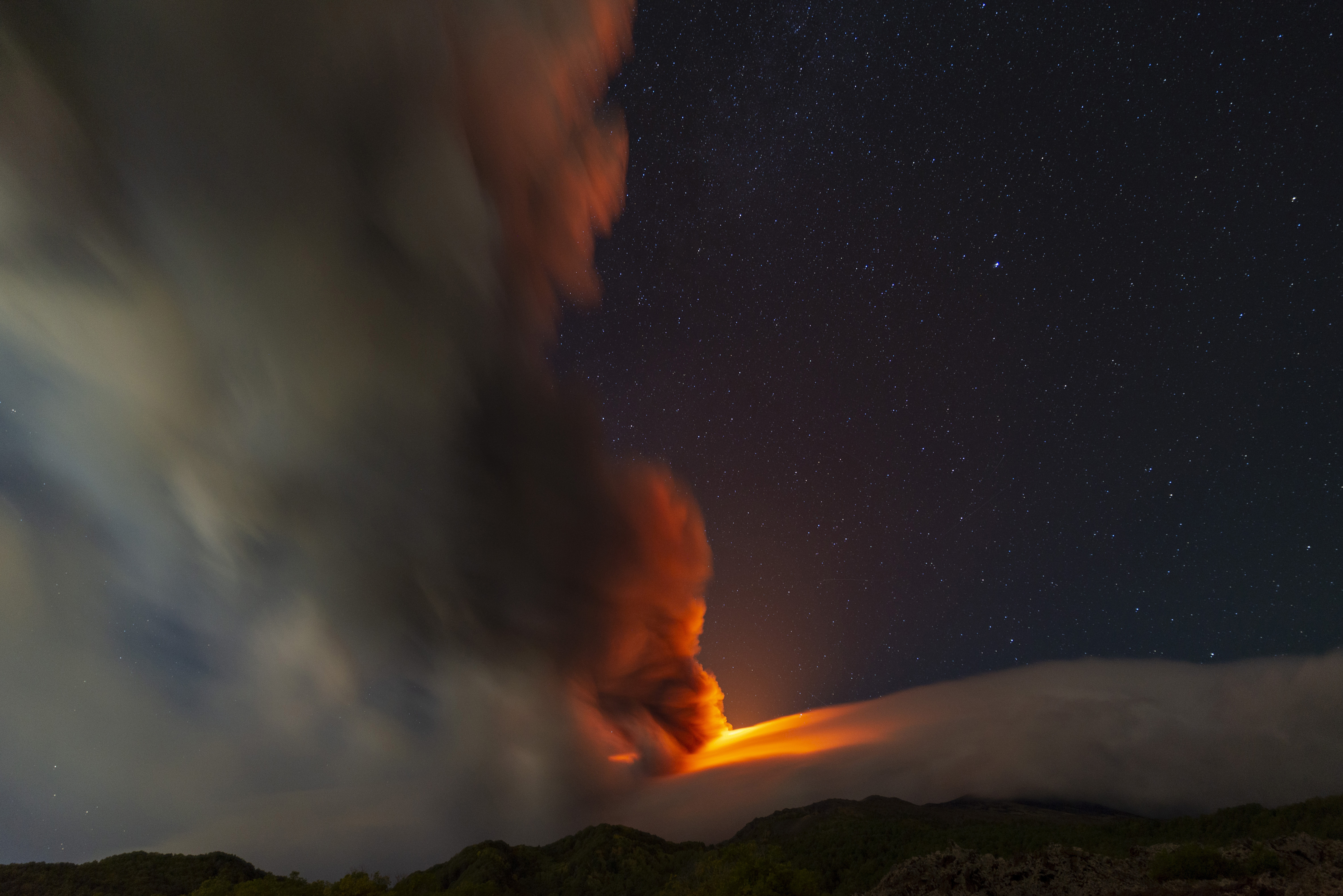 Smoke billows from Mt. Etna volcano, as seen from an area near the village of Sant'Alfio, north of Catania, Sicily, southern Italy, Sunday, Nov. 12, 2023. (AP Photo/Salvatore Allegra)