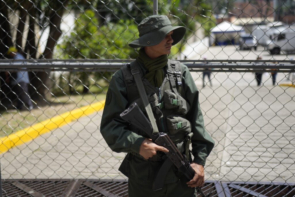 A soldier stand on guard outside of Pedro Medoza school during a rehearsal for the upcoming December referendum for the territorial dispute between Guayana and Venezuela in Caracas, Venezuela, Sunday, Nov. 19, 2023. (AP Photo/Ariana Cubillos)