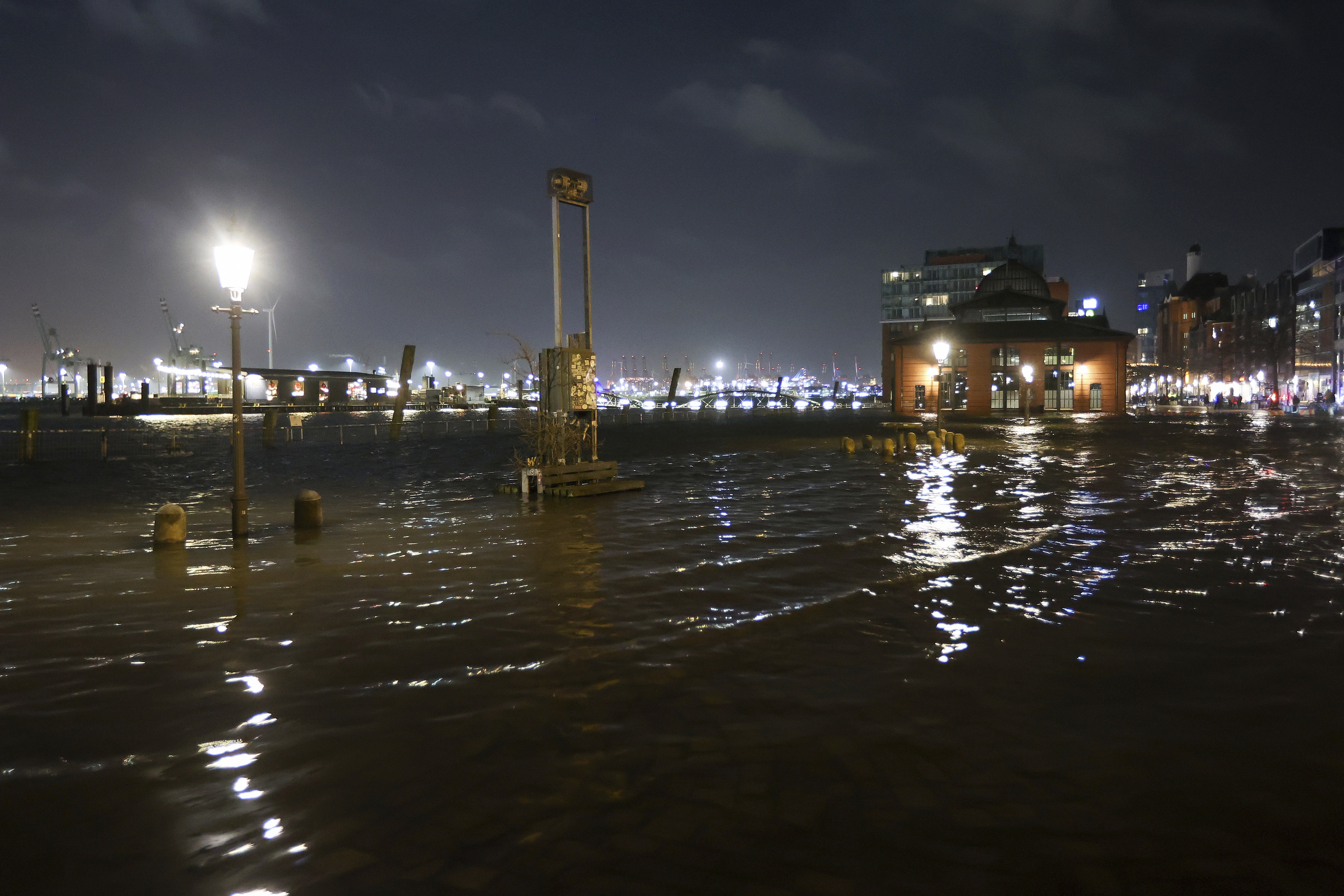 The fish market is flooded during a storm surge in Hamburg, Germany, Thursday, Dec. 21, 2023. The Federal Maritime and Hydrographic Agency predicted a severe storm surge in Hamburg overnight due to the storm depression "Zoltan." (Bodo Marks/dpa via AP)