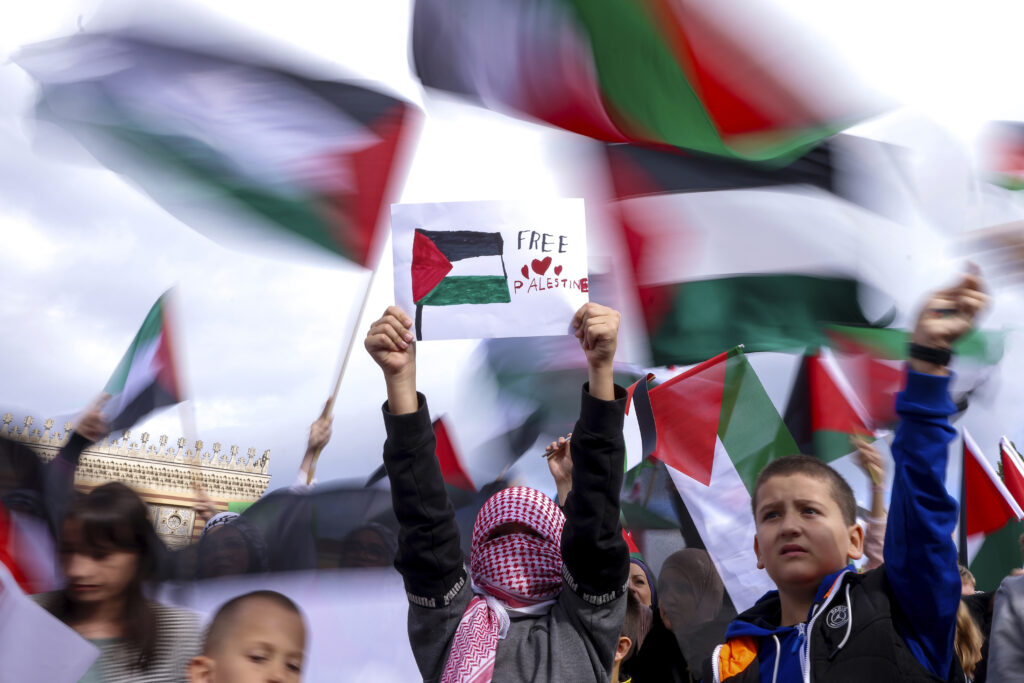 Boy holds a paper saying "free Palestine" during a protest against Israel and in support of Palestinians in Sarajevo, Bosnia, Sunday, Oct. 22, 2023. (AP Photo/Armin Durgut)