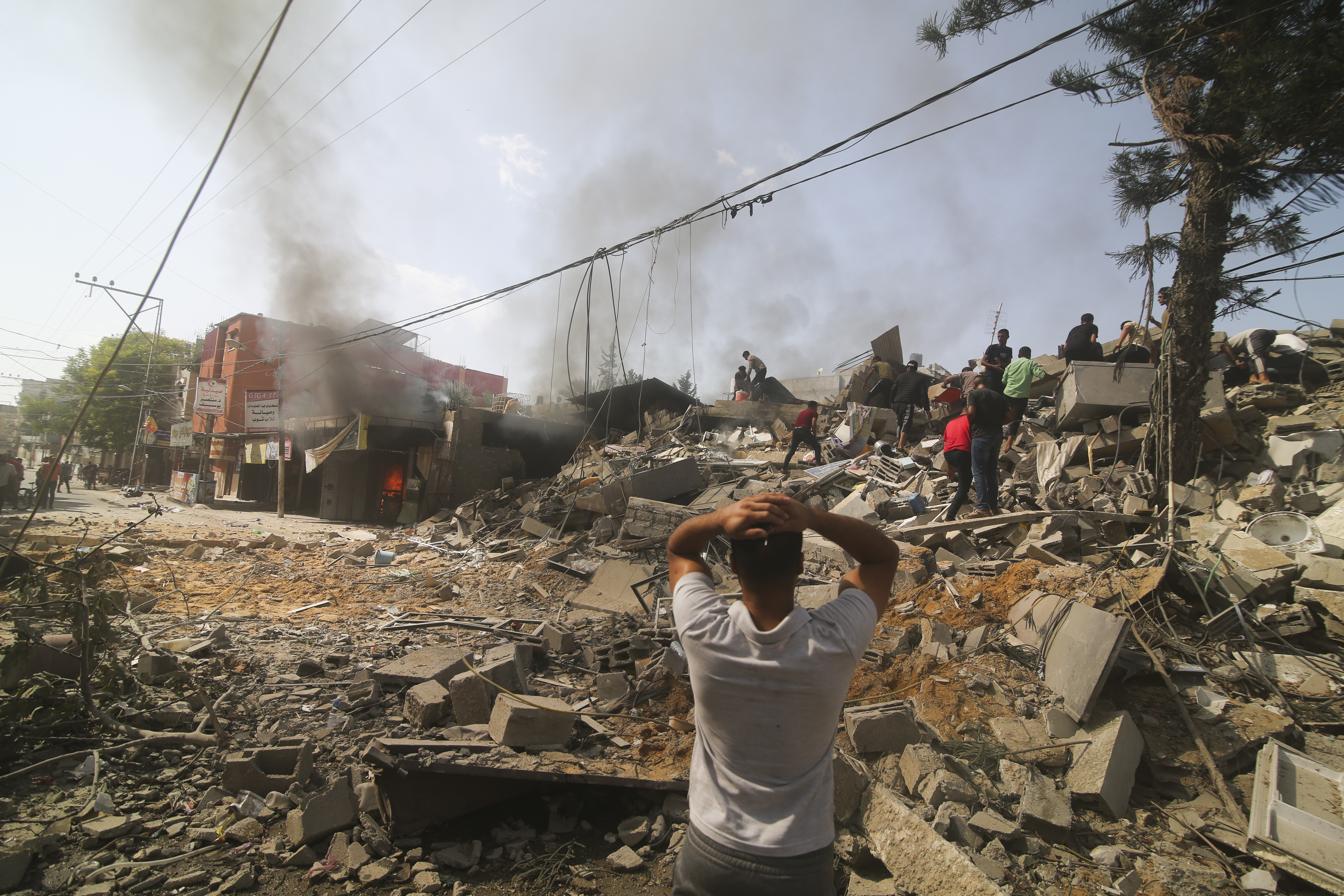 Palestinians look for survivors of the Israeli bombardment of the Gaza Strip in Rafah on Monday, Oct. 23, 2023. (AP Photo/Hatem Ali)