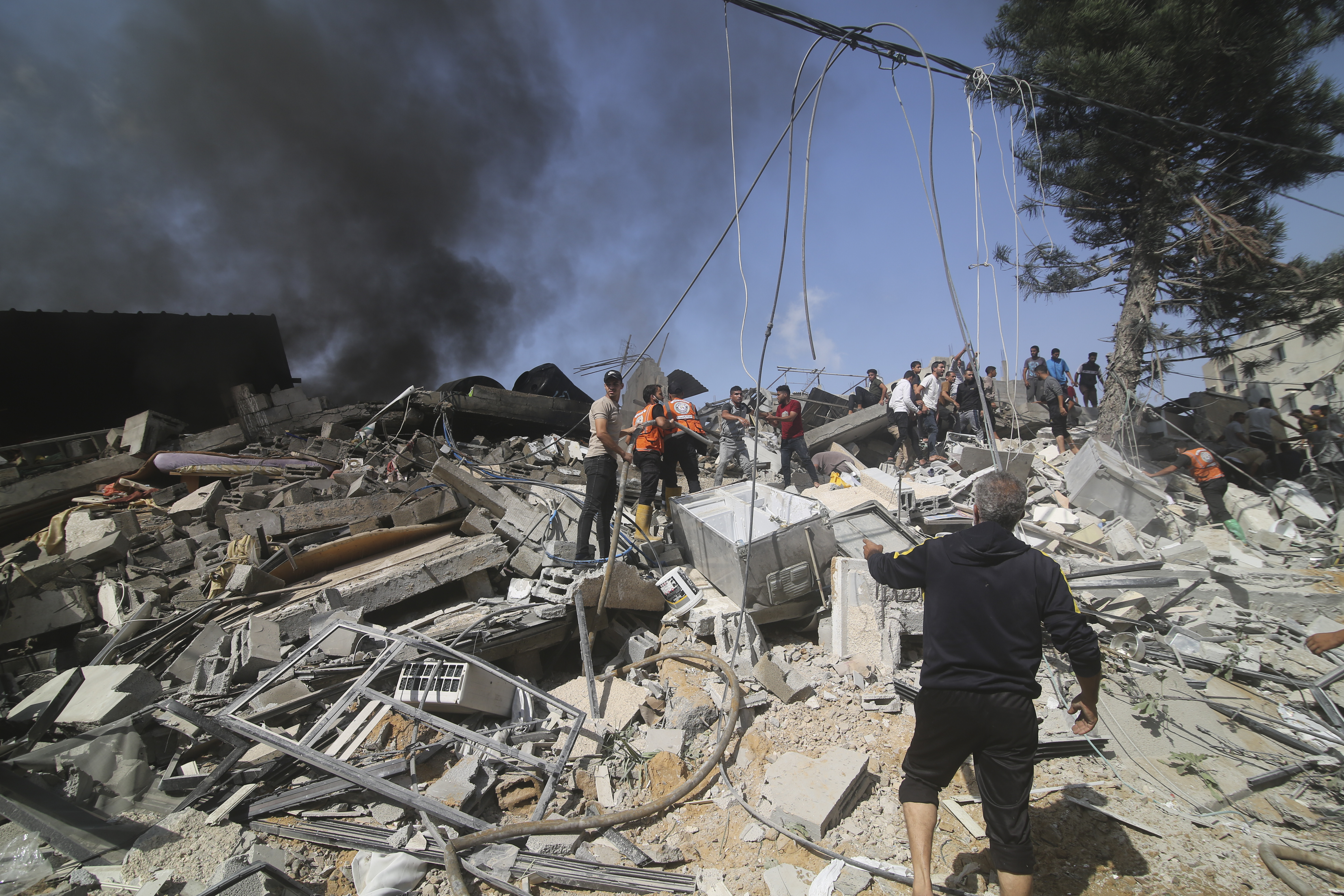 Palestinians look for survivors of the Israeli bombardment of the Gaza Strip in Rafah on Monday, Oct. 23, 2023. (AP Photo/Hatem Ali)