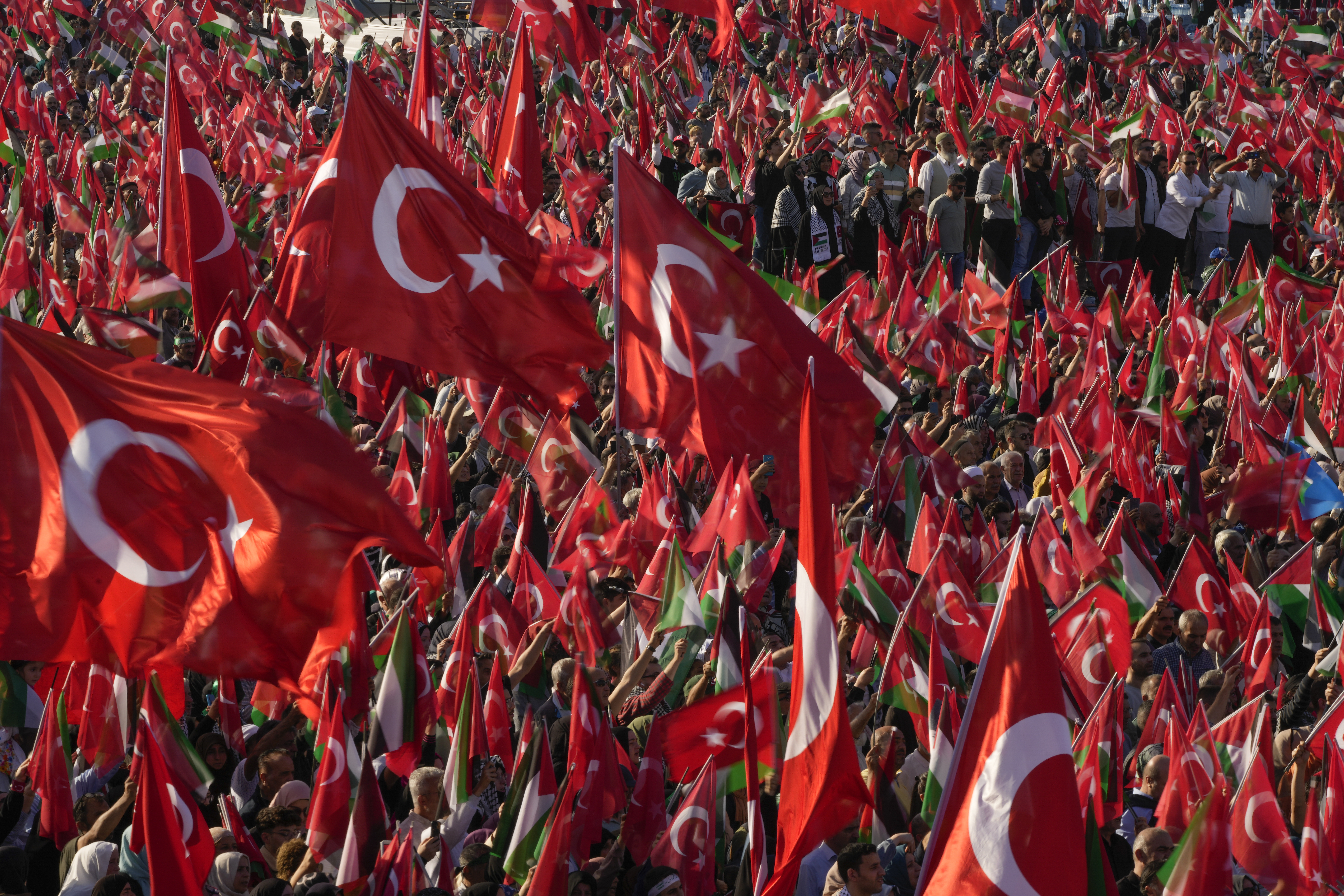 Protesters wave Turkish and Palestinian flags while attending a rally to show their solidarity with the Palestinians, in Istanbul, Turkey, Saturday, Oct. 28, 2023. (AP Photo/Emrah Gurel)