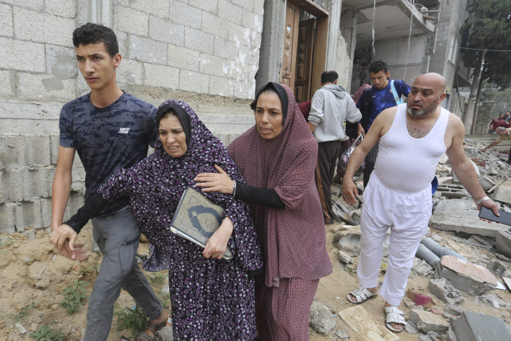 Palestinians evacuate a building destroyed in the Israeli bombardment of the Gaza Strip in Rafah on Sunday, Oct. 29, 2023. (AP Photo/Hatem Ali)