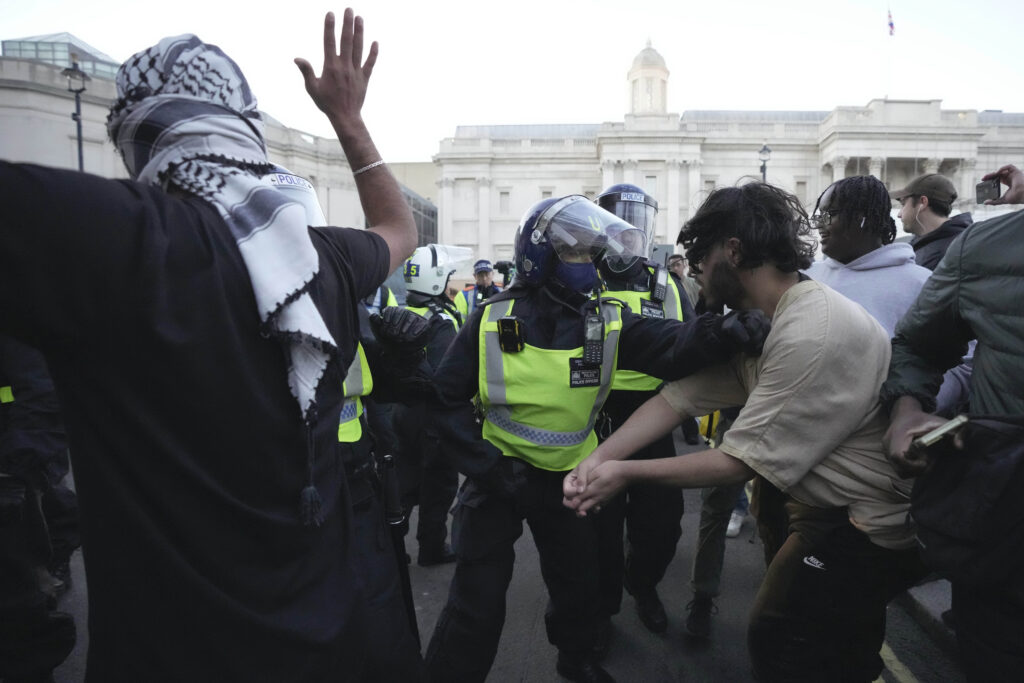 Protesters scuffle with police during a pro Palestinian demonstration in London, Saturday, Oct. 14, 2023, in support of Palestinians caught up in the war between Israel and Hamas. (AP Photo/Kin Cheung)