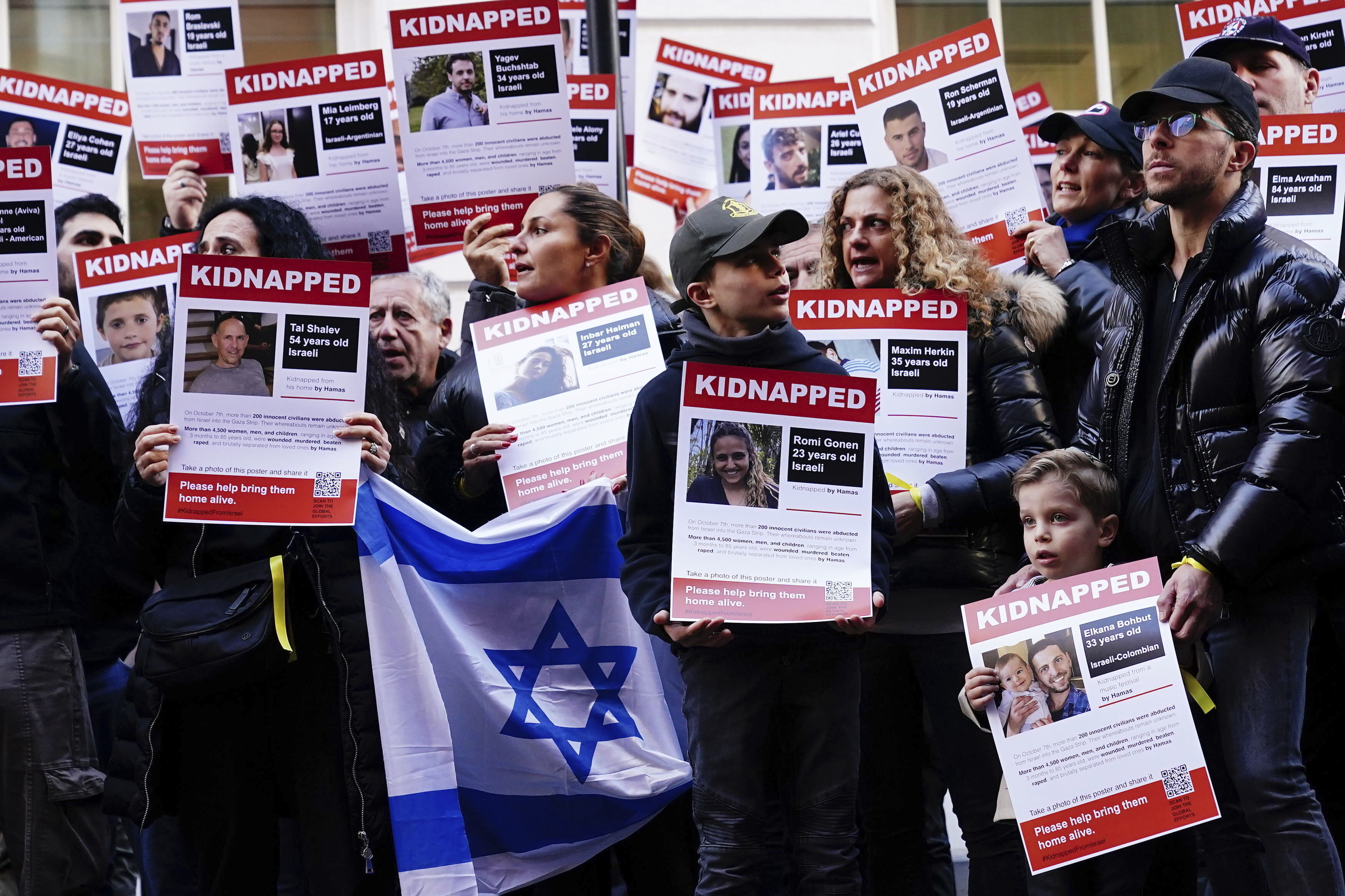 People take part in a gathering of unity and solidarity in front of the Embassy of Qatar in London, calling for the release of hostages kidnapped from Israel, Sunday October 29, 2023. (Aaron Chown/PA via AP)