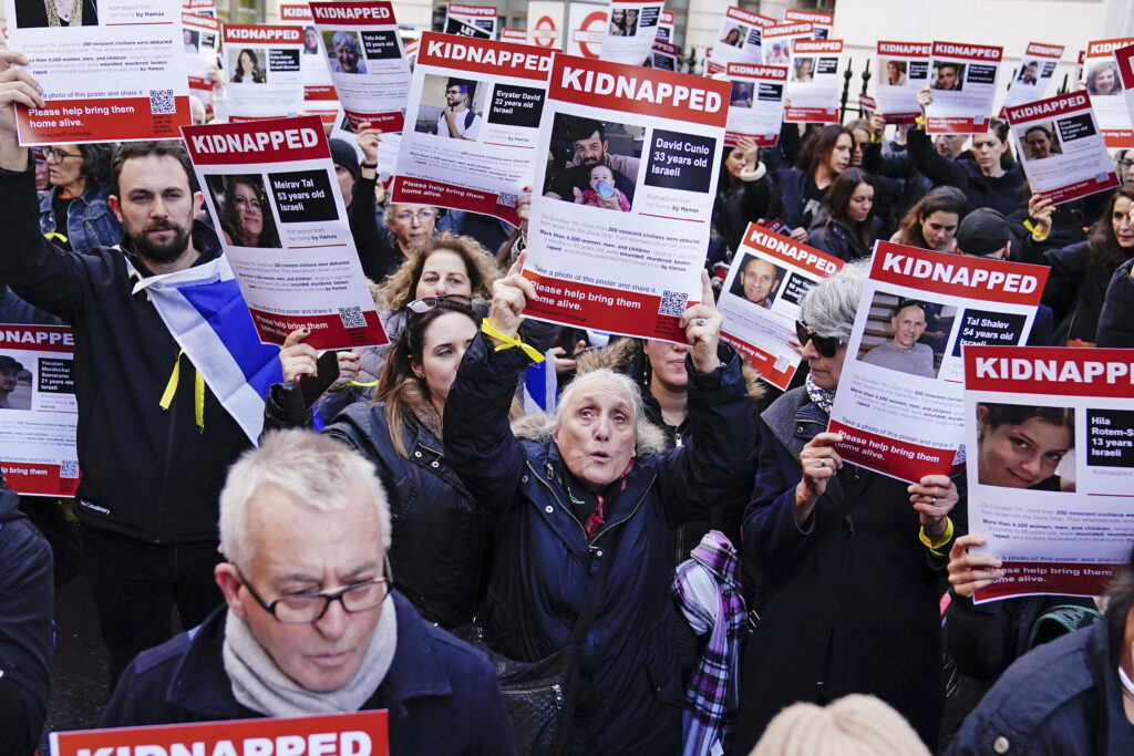 People take part in a gathering of unity and solidarity in front of the Embassy of Qatar in London, calling for the release of hostages kidnapped from Israel, Sunday October 29, 2023. (Aaron Chown/PA via AP)