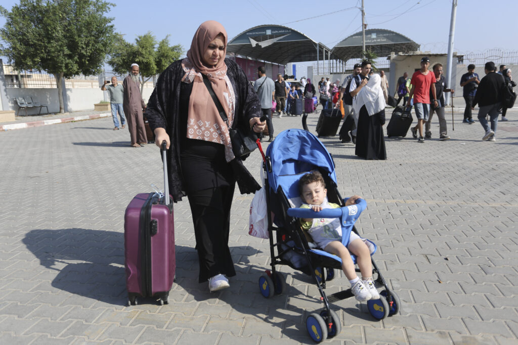 Palestinians cross to the Egyptian side of the border crossing with the Gaza Strip Wednesday, Nov. 1, 2023. in Rafah Wednesday, Nov. 1, 2023. (AP Photo/Hatem Ali)