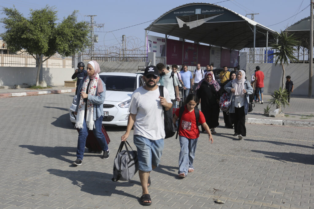 Palestinians cross to the Egyptian side of the border crossing with the Gaza Strip Wednesday, Nov. 1, 2023. in Rafah Wednesday, Nov. 1, 2023. (AP Photo/Hatem Ali)