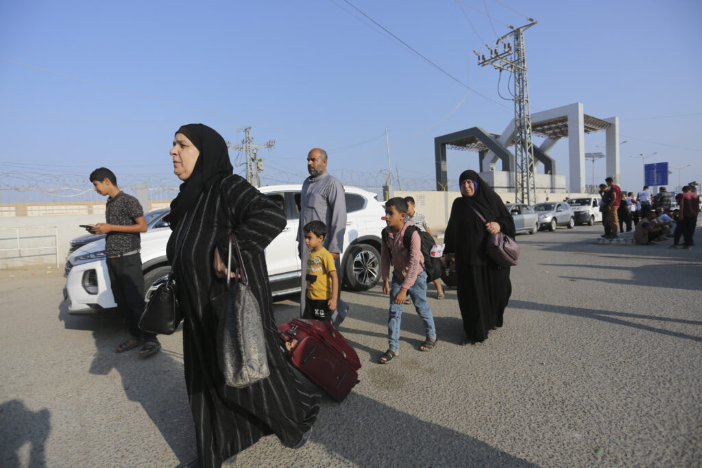 Palestinains wait at The border crossing bwteen Gaza Strip and Egypt in Rafah, Wednesday, Nov. 1, 2023. (AP Photo/Hatem Ali)