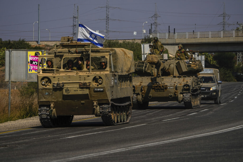 Israeli soldiers move towards the Gaza Strip border in southern Israel Wednesday, Nov.1, 2023. Israeli ground forces have been operating in Gaza in recent days as Israel presses ahead with its war against Hamas militants. (AP Photo/Ariel Schalit)