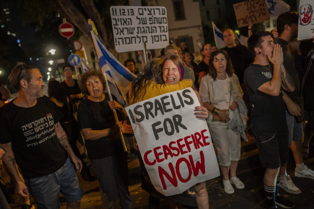 An Israeli woman calling for a ceasefire in the Gaza Strip is comforted by another protester after an argument with a right-wing Israeli in Tel Aviv, Israel, Saturday, Nov. 4, 2023. (AP Photo/Bernat Armangue)