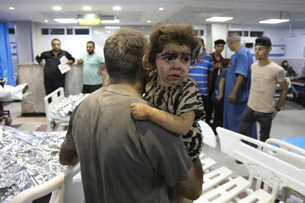 Wounded Palestinians arrive at the al-Shifa hospital, following Israeli airstrikes on Gaza City, central Gaza Strip, Thursday, Oct. 19, 2023. (AP Photo/Abed Khaled)