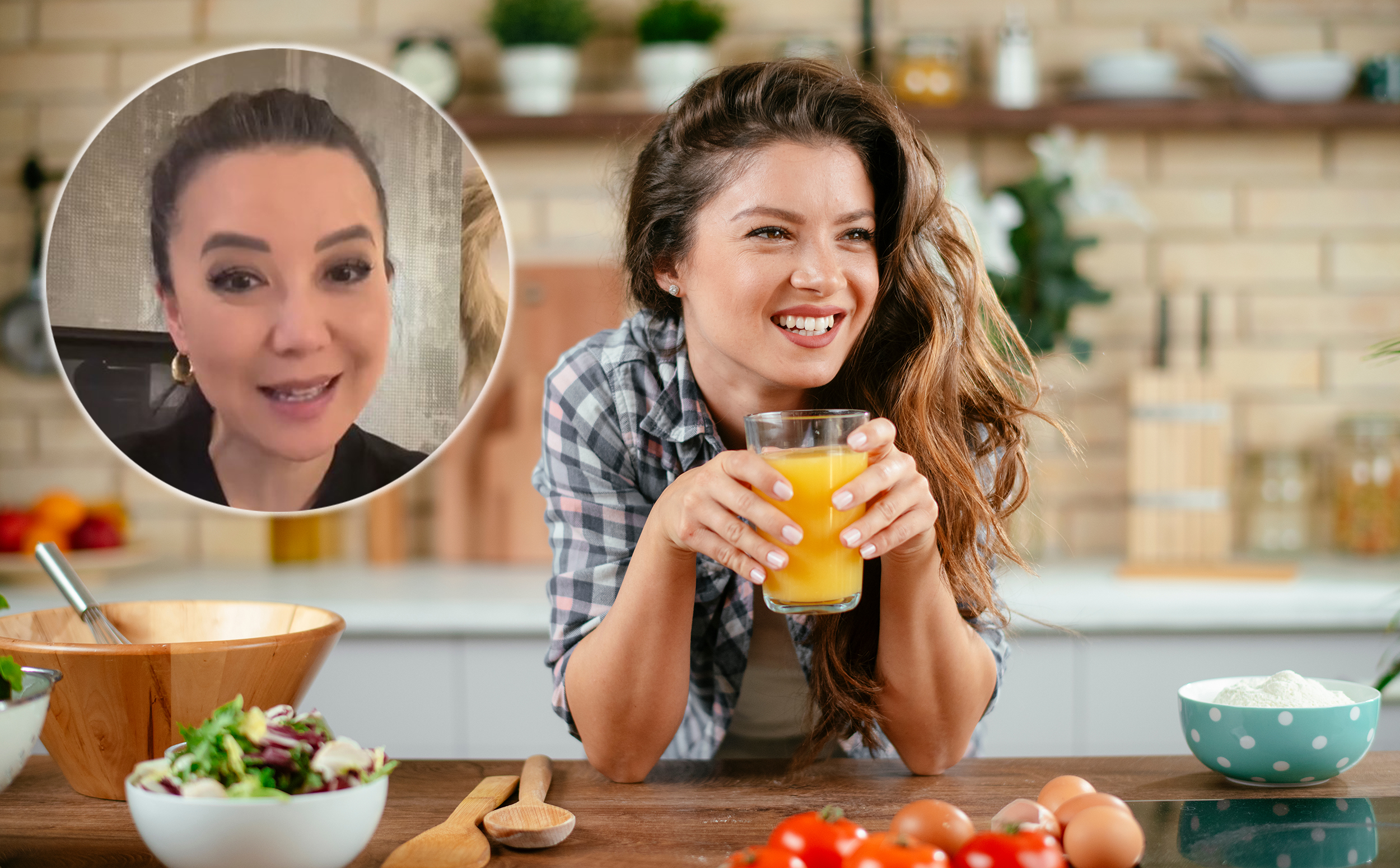 Beautiful woman drinking orange healty orange juice in the kitchen