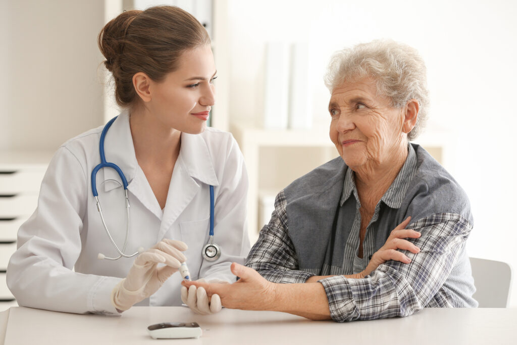 Doctor measuring blood sugar level of diabetic patient in clinic dijabetes