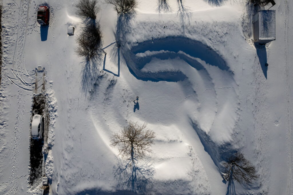 epa10448843 A picture taken with a drone shows a blanket of snow covers an amphitheatre-like open air community structure in Aiton, Transylvania, Romania, 05 February 2023.  EPA-EFE/GABOR KISS HUNGARY OUT
