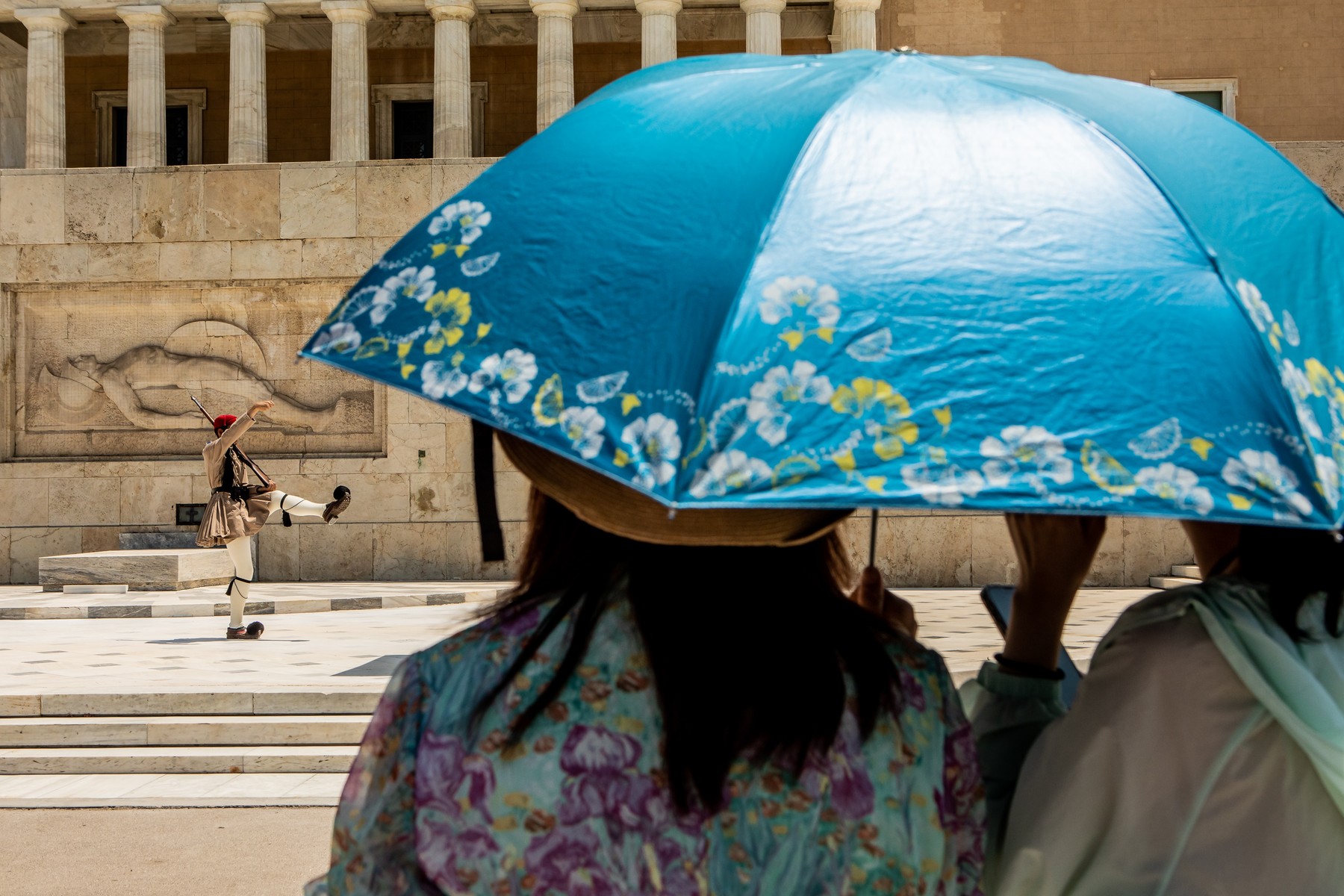 ATHENS, July 13, 2023  -- People shelter from the sun under an umbrella in Athens, Greece, July 12, 2023.,Image: 788900028, License: Rights-managed, Restrictions: , Model Release: no, Credit line: Panagiotis Moschandreou / Xinhua News / Profimedia