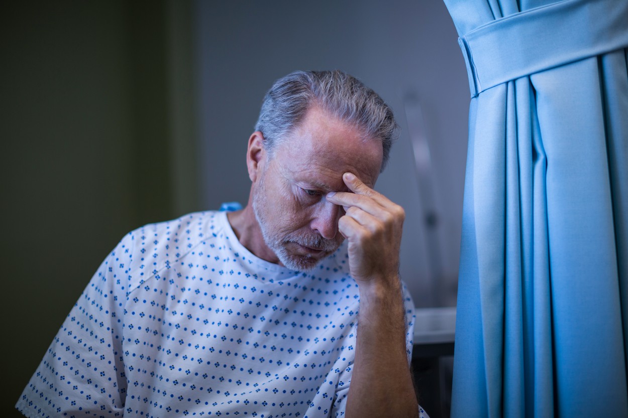 Sad patient sitting on chair with hand on head at hospital,Image: 309290391, License: Rights-managed, Restrictions: , Model Release: yes, Credit line: - / Wavebreak / Profimedia