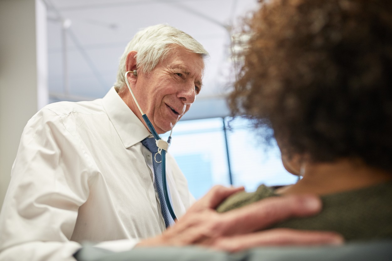 Doctor comforting patient in clinic
