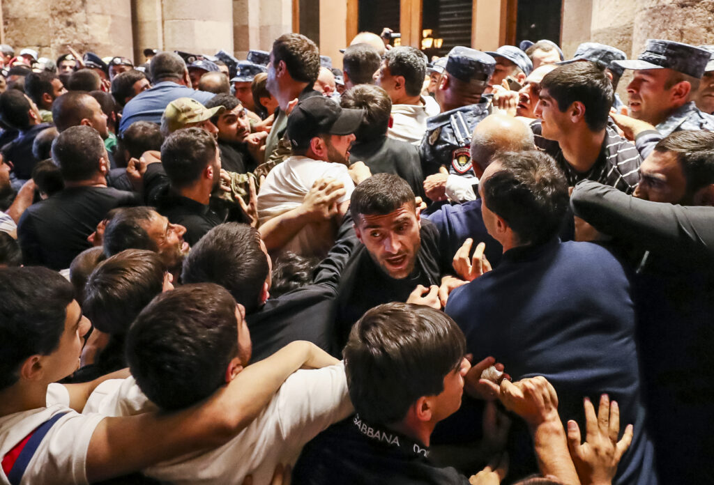 Demonstrators clash with police at the Armenia government building to protest against Prime Minister Nikol Pashinyan in Yerevan, Armenia, Tuesday, Sept. 19, 2023. (Vahram Baghdasaryan/Photolure via AP)