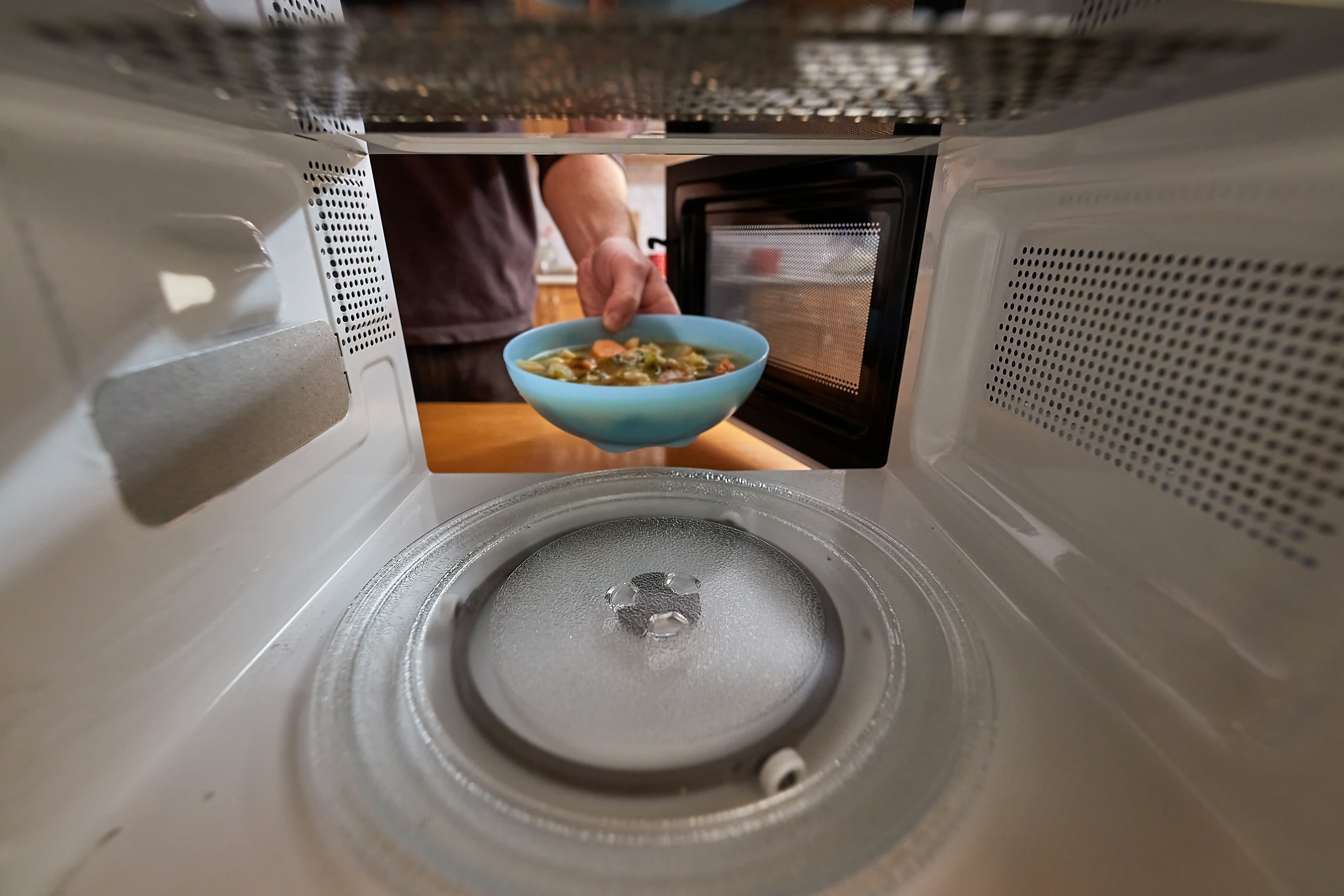 Heating food in a microwave viewed from inside the back,  a bowl of vegetable soup,Image: 746626165, License: Royalty-free, Restrictions: , Model Release: no, Credit line: Péter Gudella / Panthermedia / Profimedia