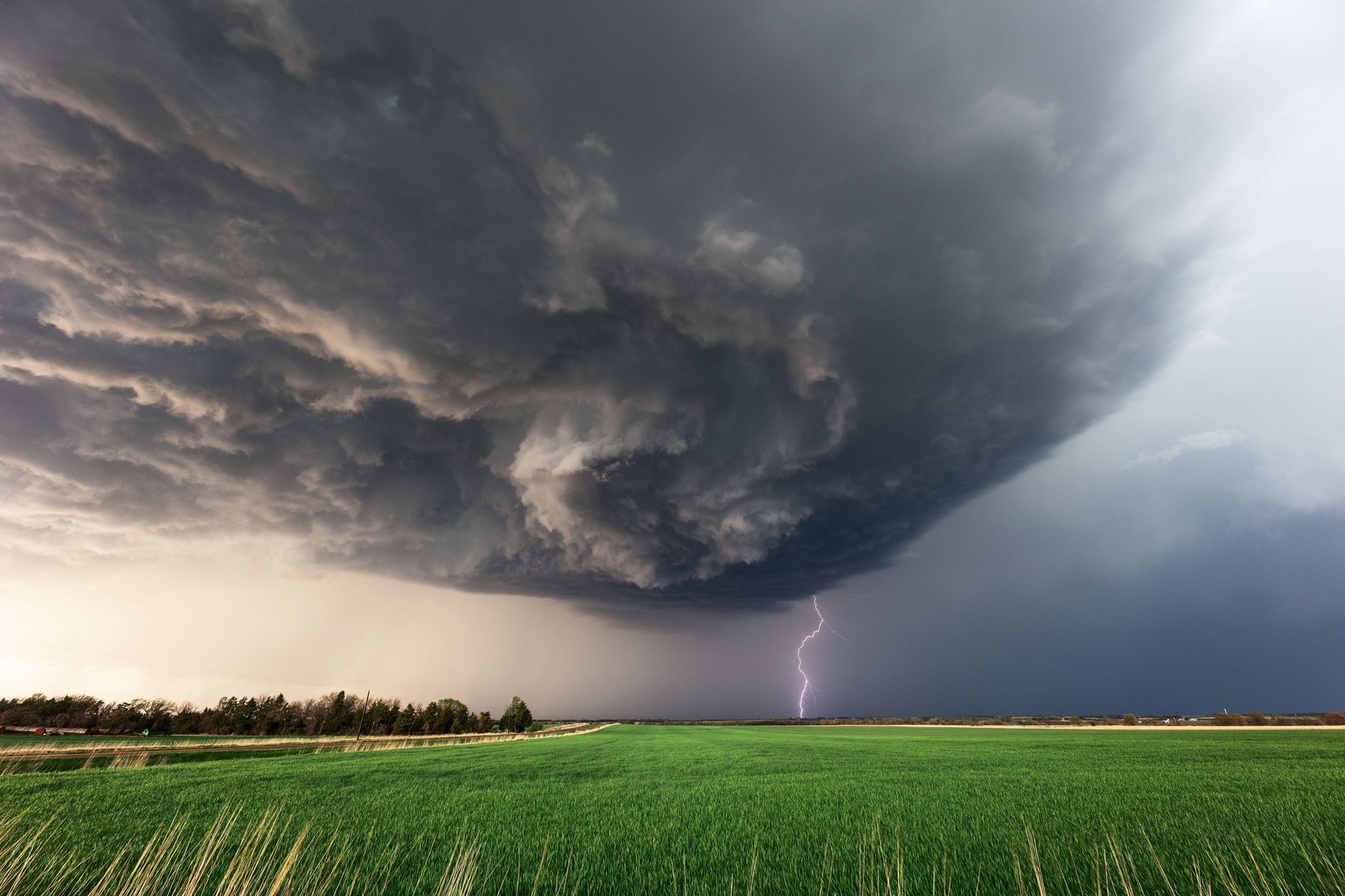 Dramatic storm clouds and lightning beneath a supercell thunderstorm near Herington, Kansas