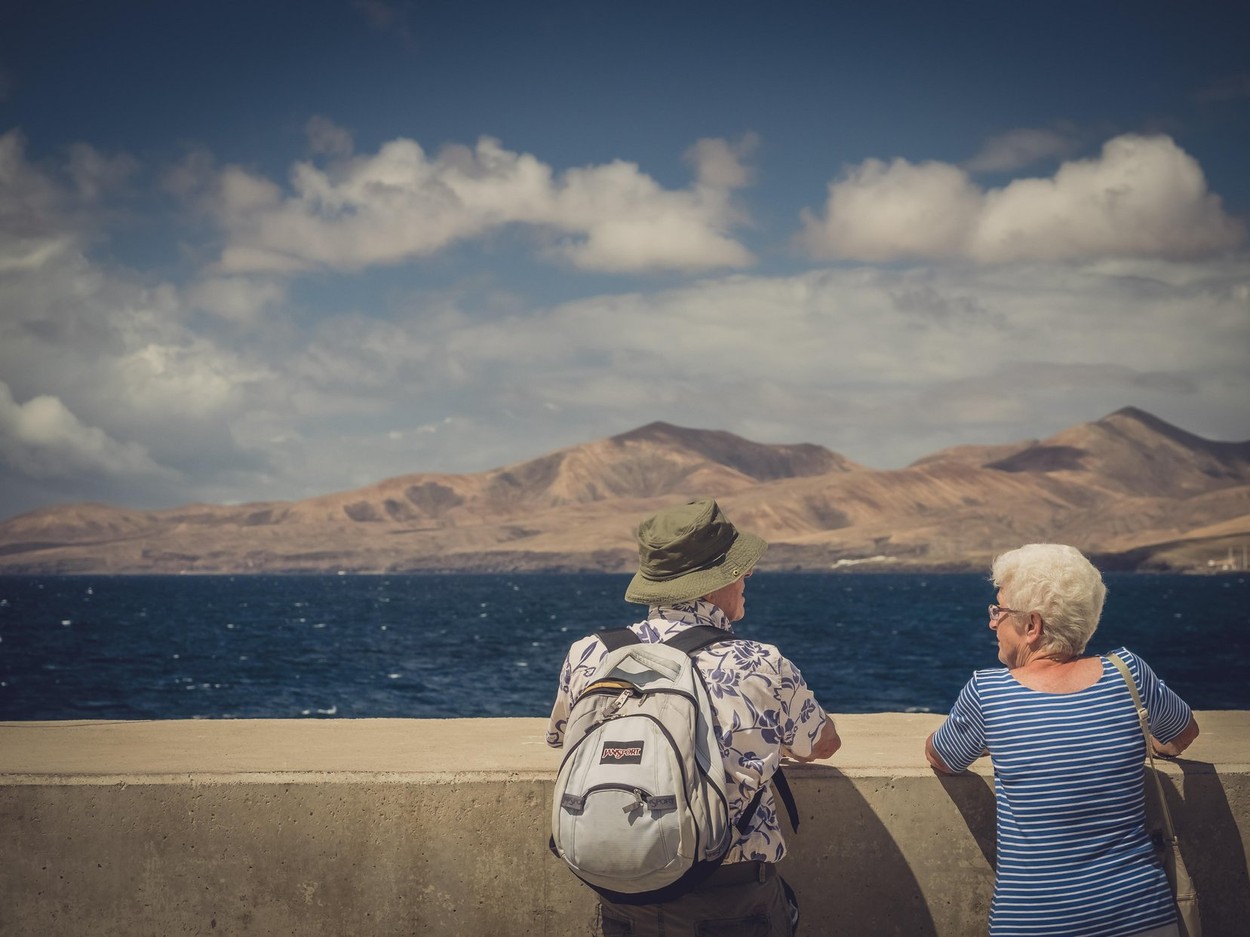 Old couple looking at sea