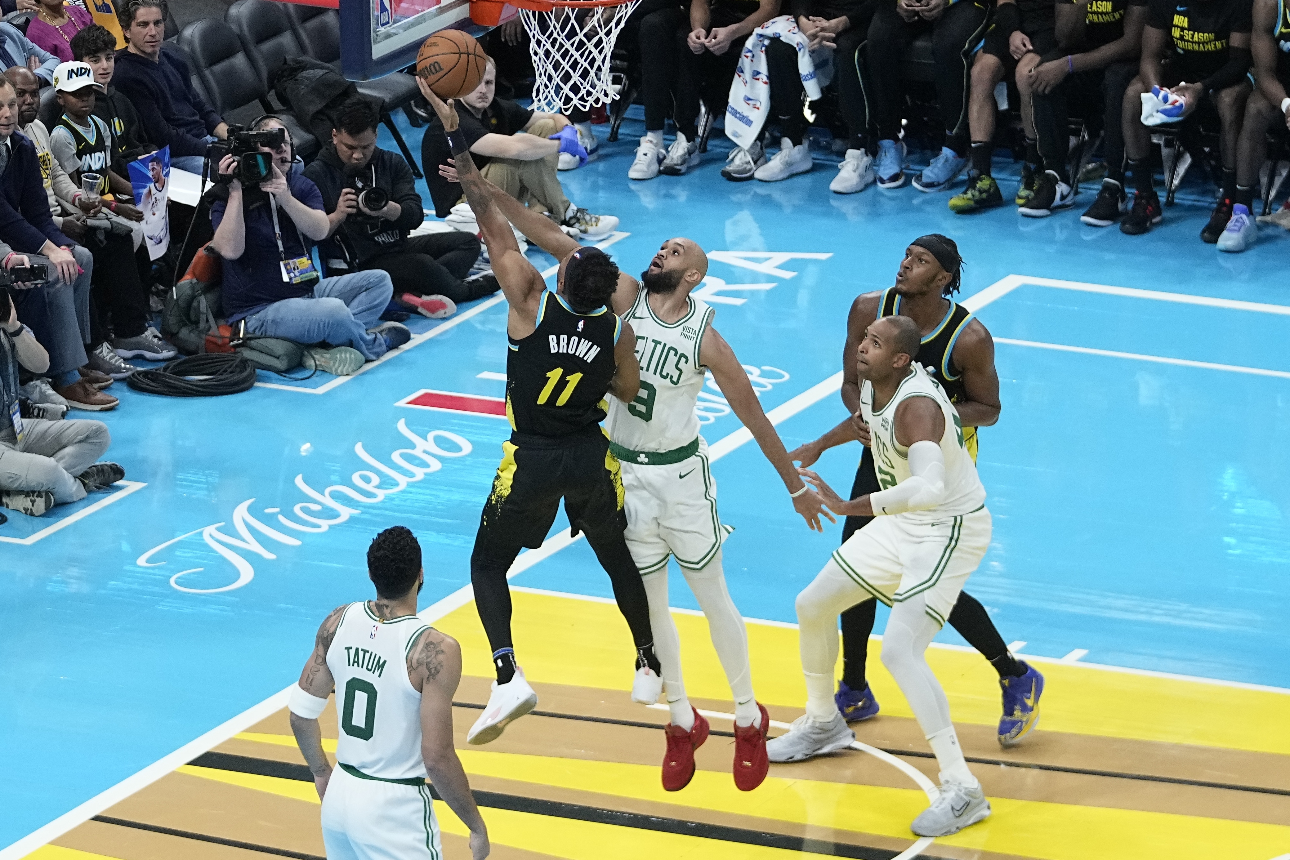 Indiana Pacers' Bruce Brown (11) shoots against Boston Celtics' Derrick White (9) during the second half of an NBA basketball In-Season Tournament game, Monday, Dec. 4, 2023, in Indianapolis. (AP Photo/Darron Cummings)