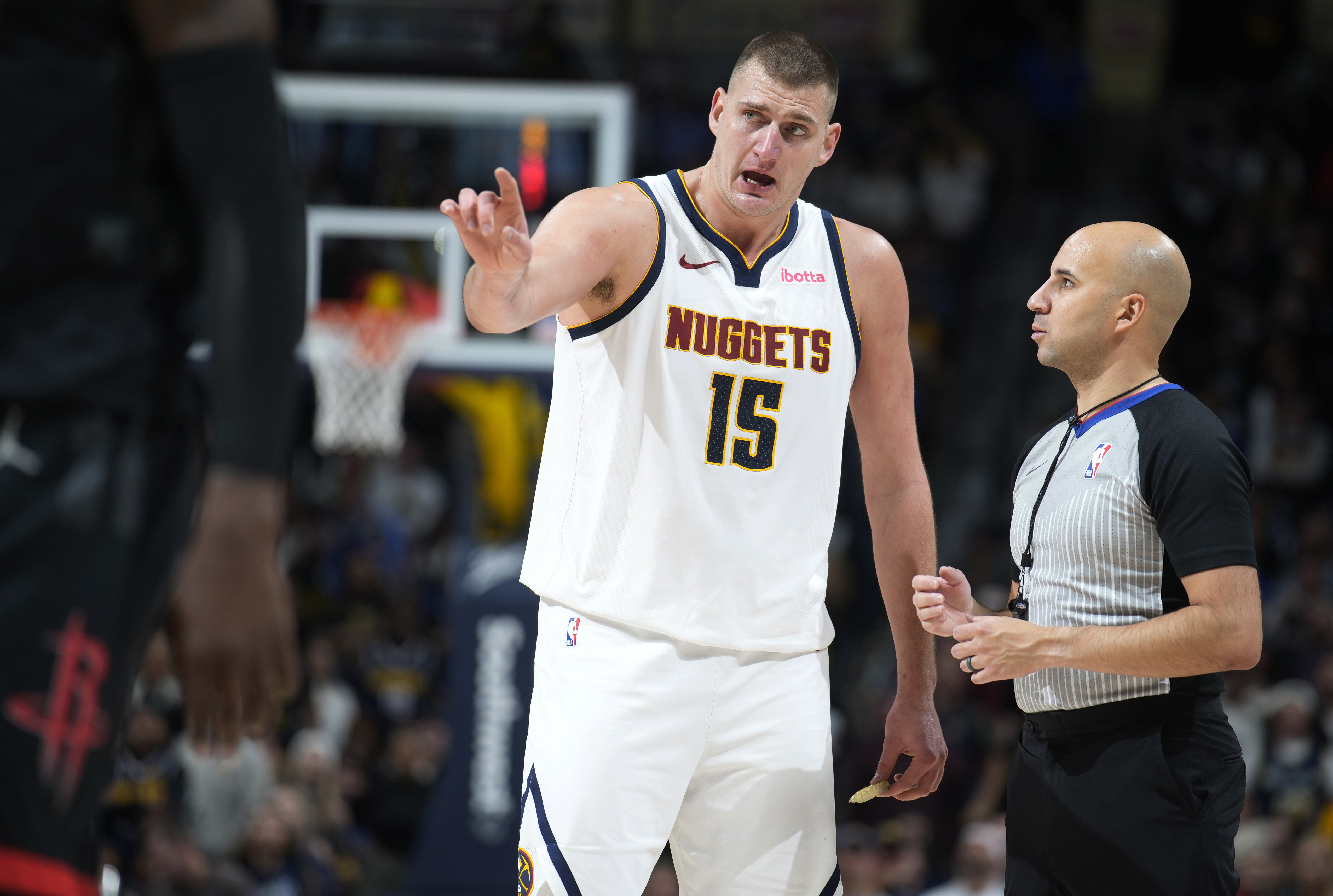 Denver Nuggets center Nikola Jokic, left, argues with referee Aaron Smith during the second half of the team's NBA basketball game against the Houston Rockets on Friday, Dec. 8, 2023, in Denver. (AP Photo/David Zalubowski)
