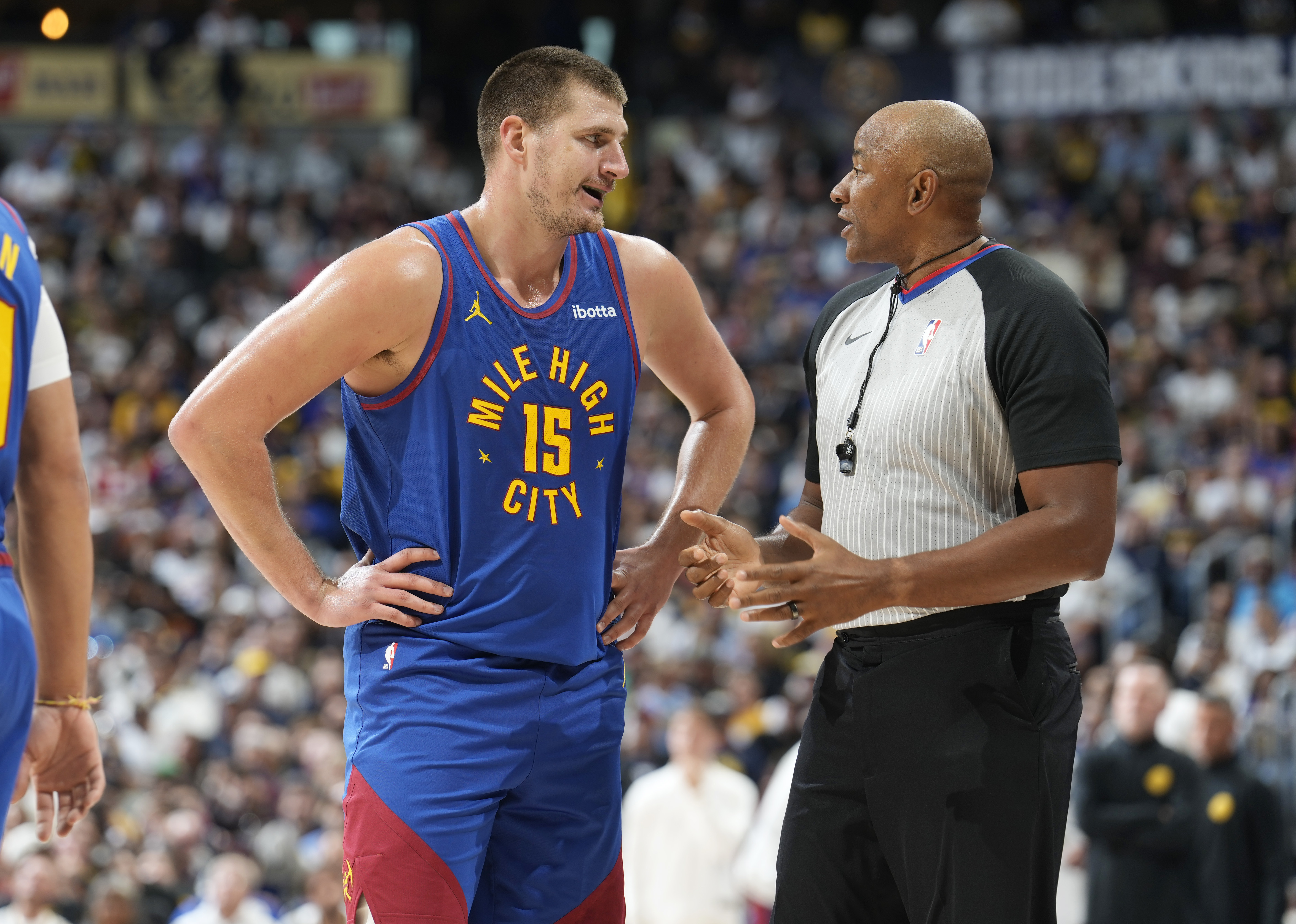 Denver Nuggets center Nikola Jokic, left, argues after he was called for a foul against the Los Angeles Lakers by referee Michael Smith during the first half of an NBA basketball game Tuesday, Oct. 24, 2023, in Denver. (AP Photo/David Zalubowski)