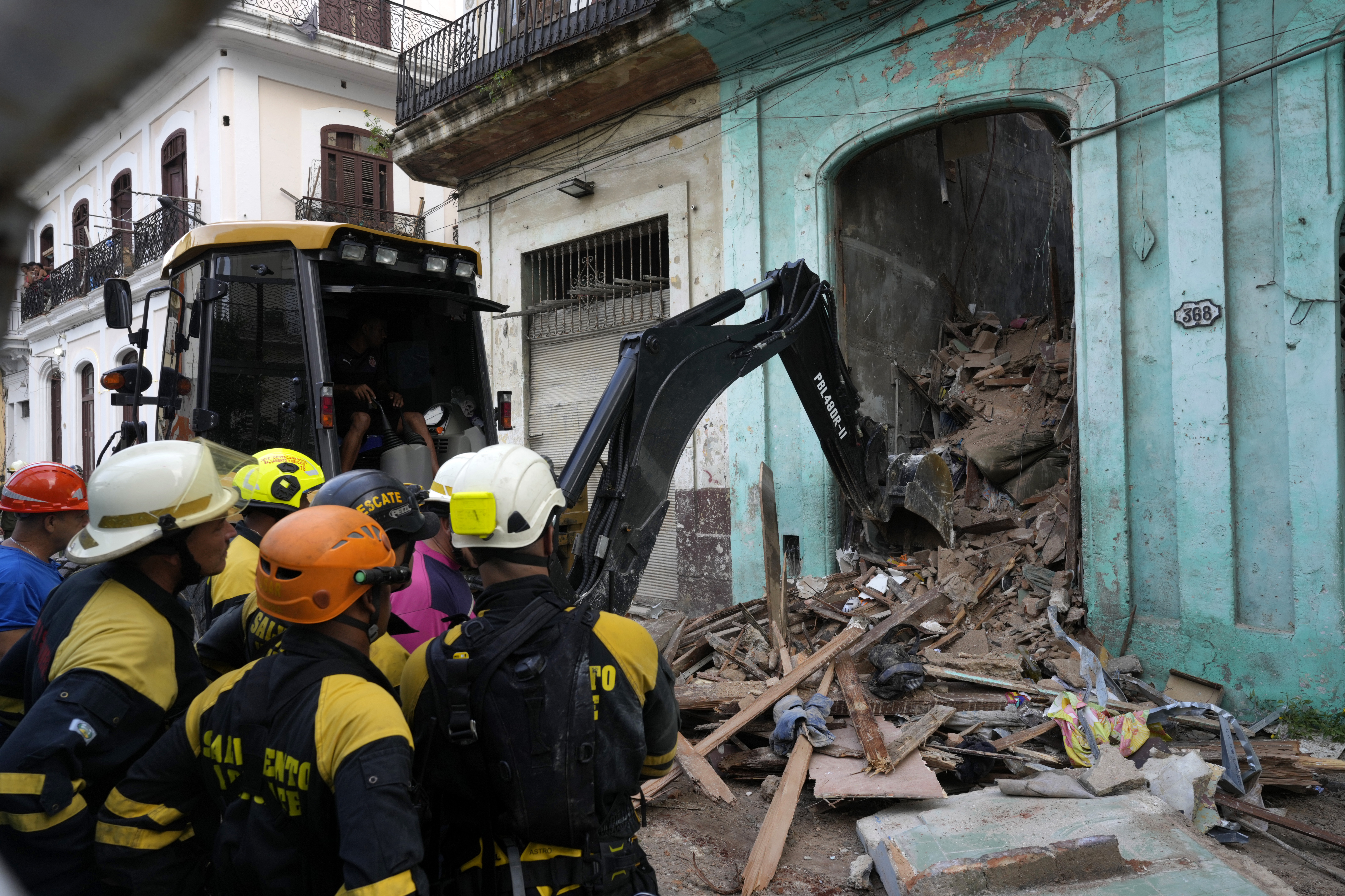 Firefighters clear debris from a building that partially collapsed in Havana, Cuba, Wednesday, Oct. 4, 2023. (AP Photo/Ramon Espinosa)