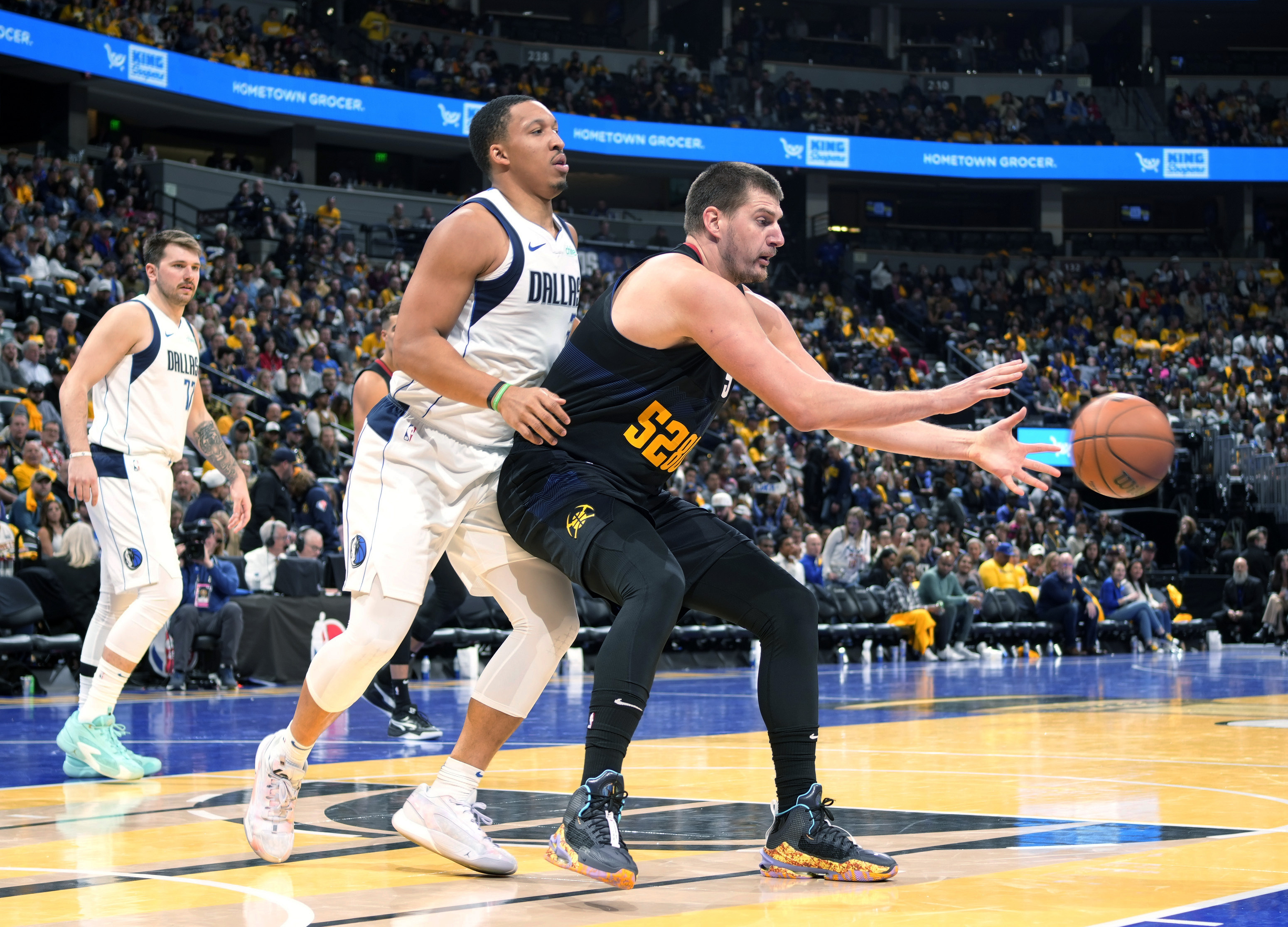 Denver Nuggets center Nikola Jokic, right, fields a pass as Dallas Mavericks forward Grant Williams defends during the second half of an NBA basketball in-season tournament game Friday, Nov. 3, 2023, in Denver. (AP Photo/David Zalubowski)