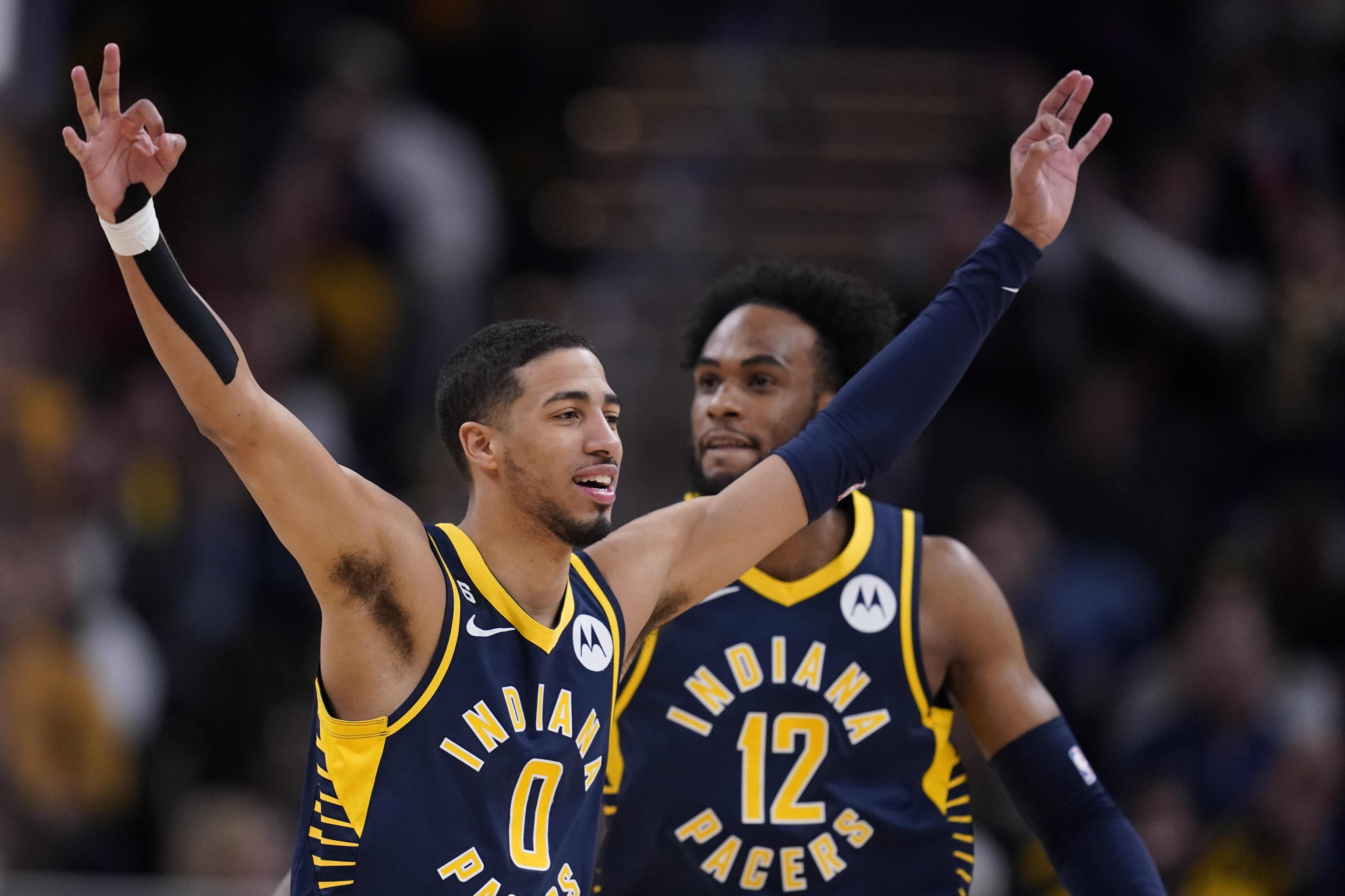 Indiana Pacers' Tyrese Haliburton (0) reacts after a 3-point basket by Buddy Hield during the second half of the team's NBA basketball game against the Atlanta Hawks, Tuesday, Dec. 27, 2022, in Indianapolis. (AP Photo/Darron Cummings)