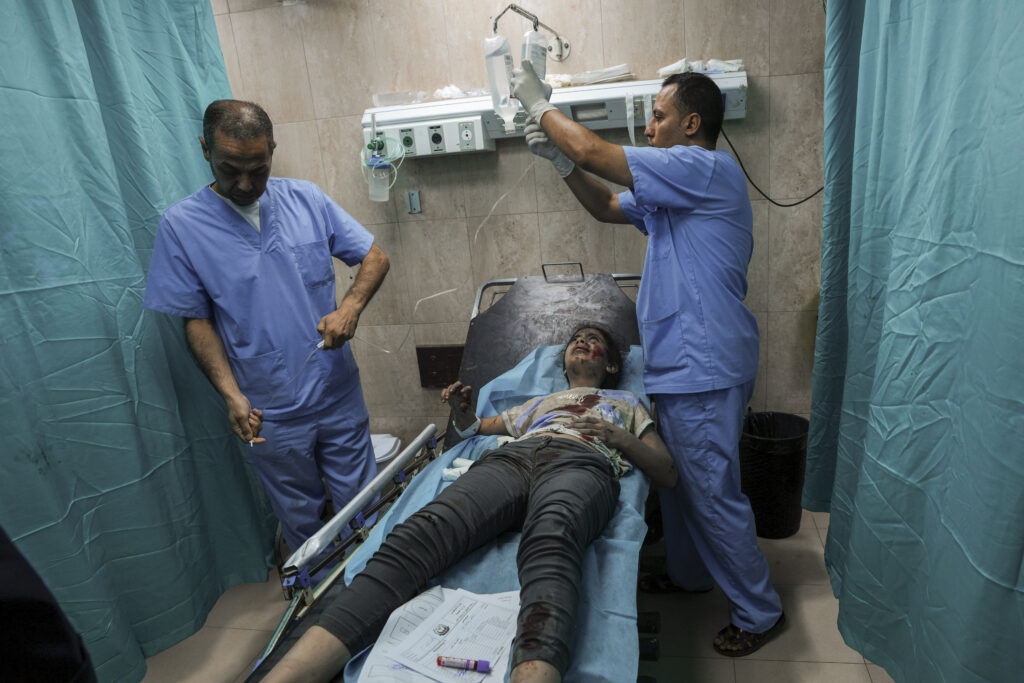 A Palestinian girl wounded during an Israeli airstrike is treated at al-Aqsa hospital in Deir el-Balah, central Gaza Strip, Sunday, Oct. 15, 2023. (AP Photo/Adel Hana)
