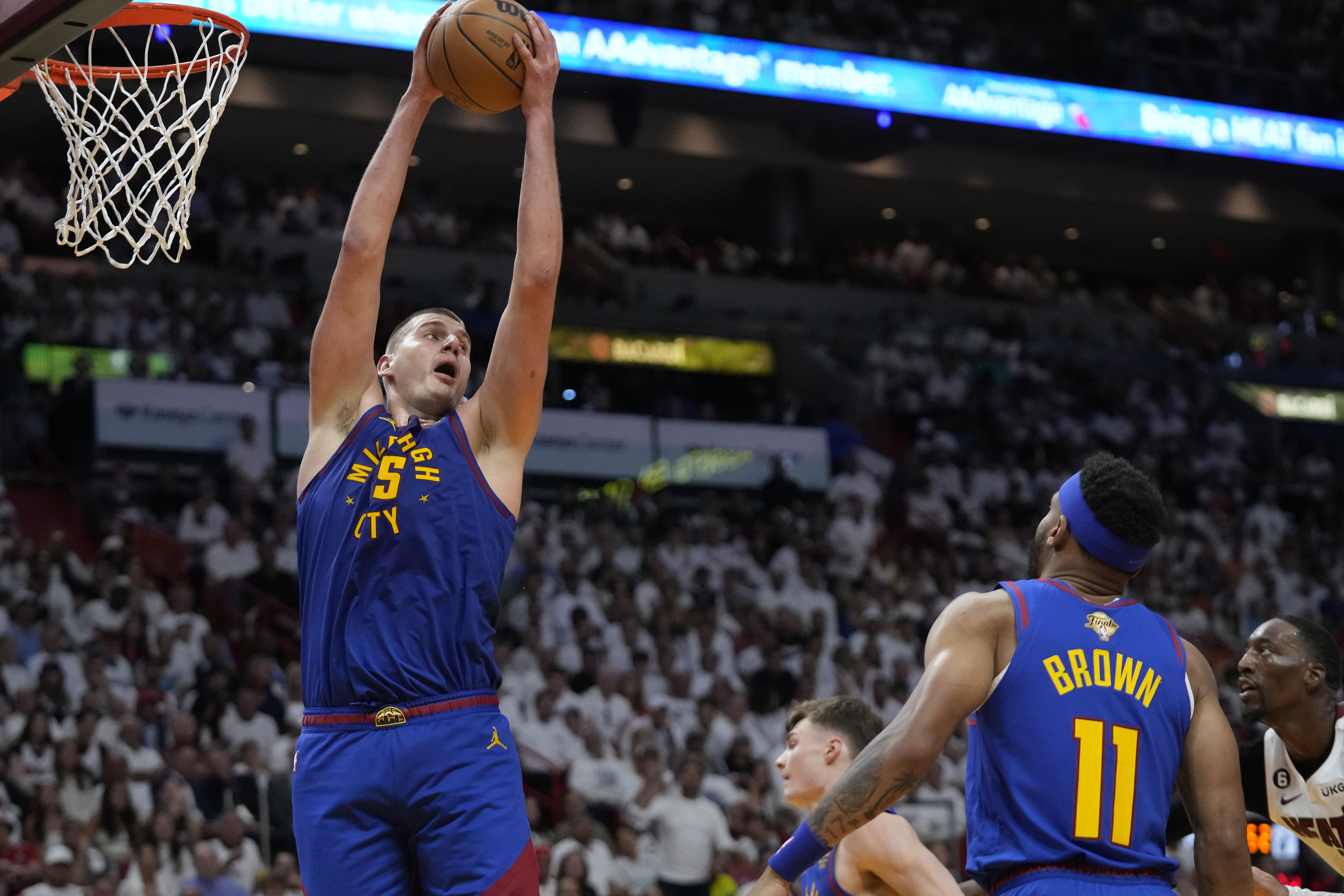 Denver Nuggets center Nikola Jokic (15) grabs a rebound during the second half of Game 3 of the NBA Finals basketball game against the Miami Heat, Wednesday, June 7, 2023, in Miami. (AP Photo/Wilfredo Lee)