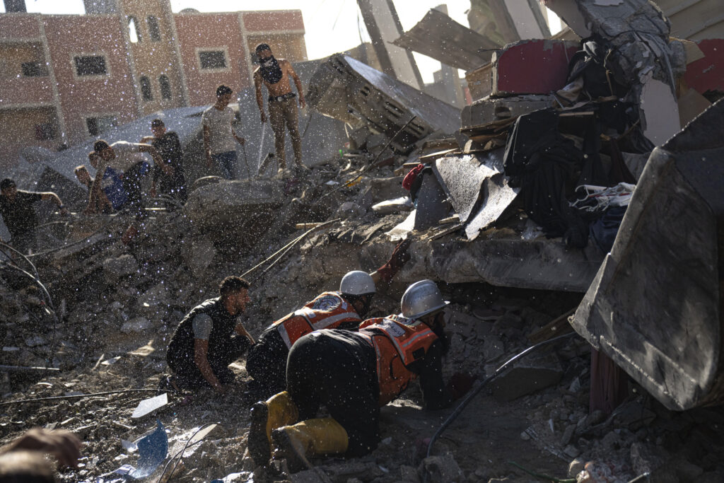 Palestinians look for survivors after an Israeli airstrike on Khan Younis, Gaza Strip, Tuesday, Oct. 17, 2023. (AP Photo/Fatima Shbair)