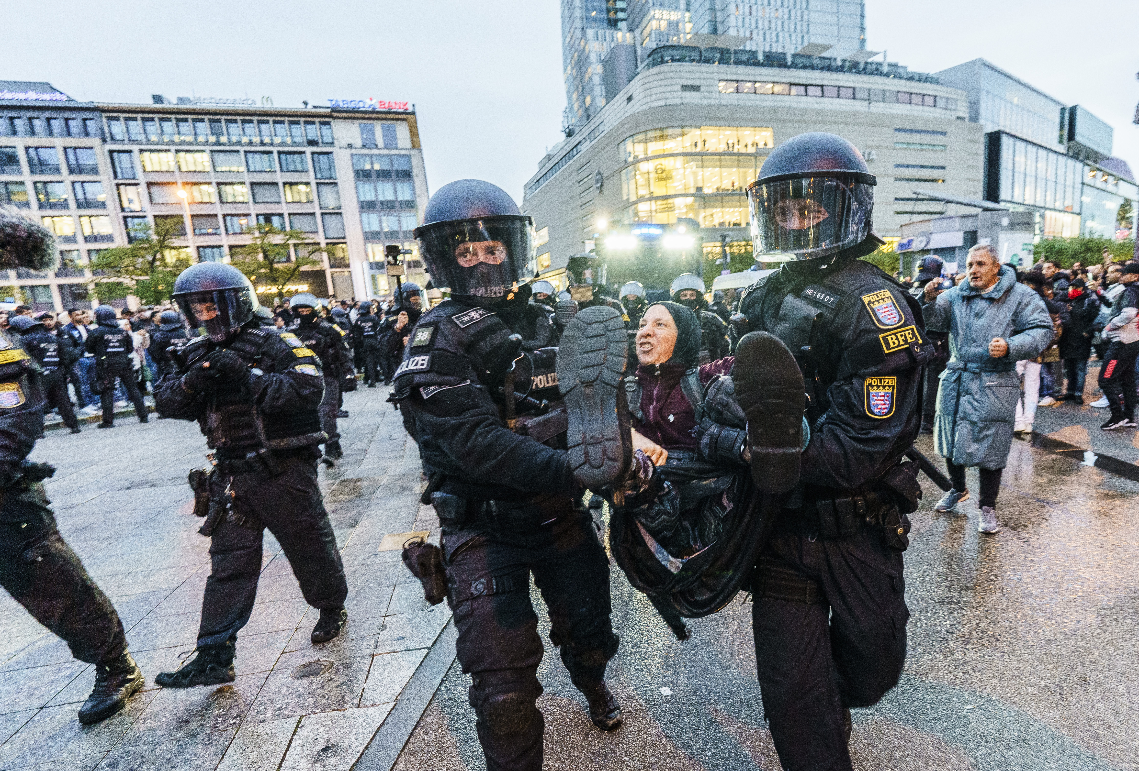 A participant in a pro-Palestinian demonstration is carried away by the police, in Frankfurt, Germany, Wednesday, Oct. 18, 2023. (Andreas Arnold/dpa via AP)