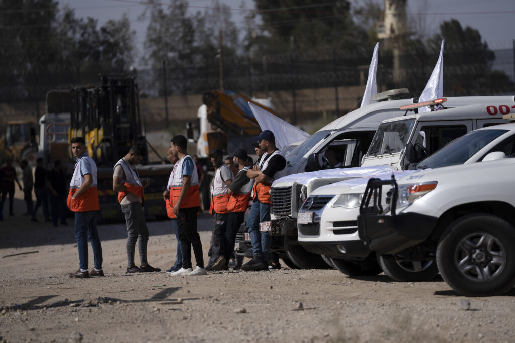International NGOs wait for humanitarian aid on the Gaza Strip side of the border with Egypt in Rafah on Saturday, Oct. 21, 2023. (AP Photo/Fatima Shbair)