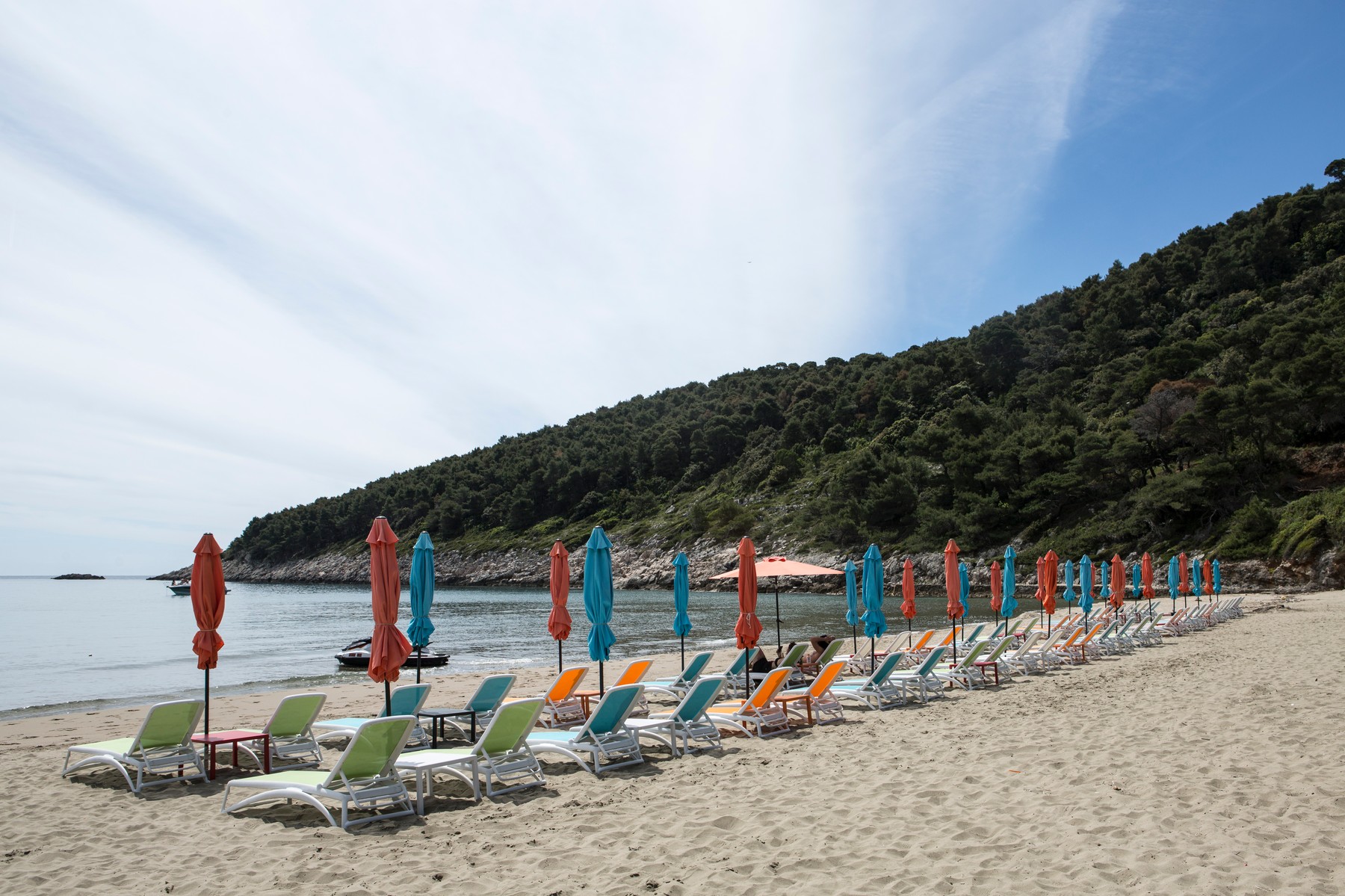 Empty beach with rows of beach umbrellas and sun loungers, Dubrovnik, Croatia