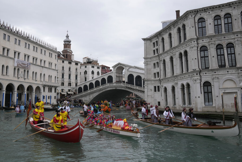Boats sail during the water parade, part of the Venice Carnival, in Venice, Italy, Sunday, Feb. 5, 2023. The Venice carnival in the historical lagoon city attracts people from around the world. (AP Photo/Antonio Calanni)