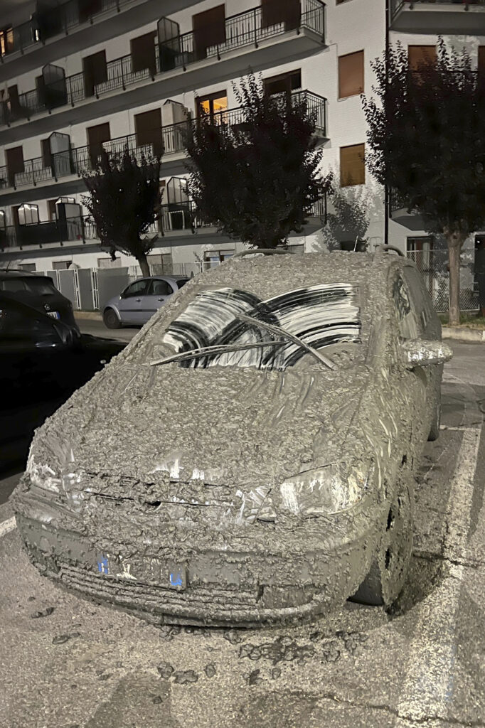 A car is covered in mud following heavy storms, which caused the flooding of a stream in Bardonecchia, Northern Italy, Sunday, Aug. 13, 2023.  (LaPresse via AP)