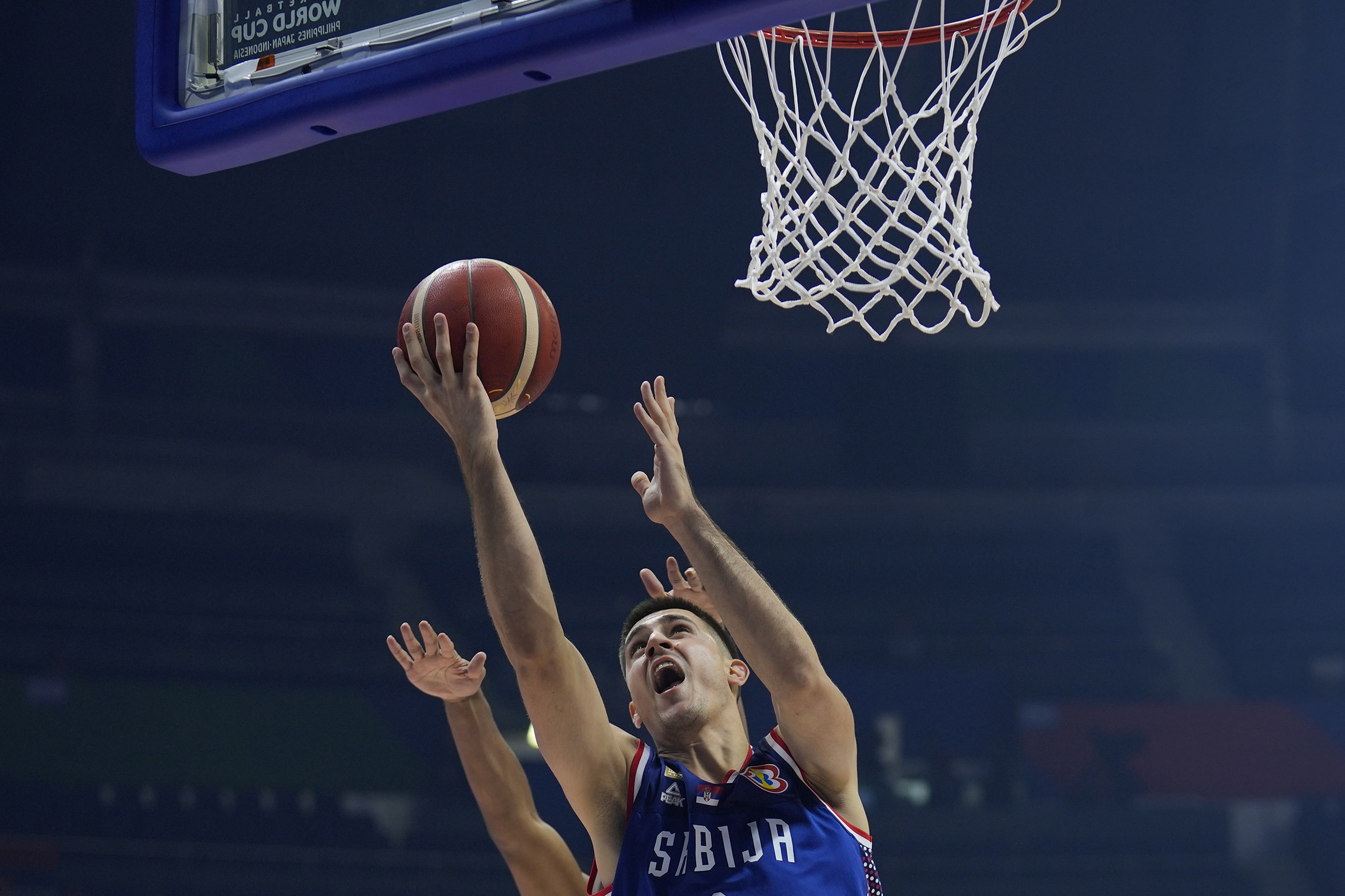 Serbia guard Vanja Marinkovic (9) shoots during their Basketball World Cup group B match against Puerto Rico at the Araneta Coliseum in Manila, Philippines Monday, Aug. 28, 2023. (AP Photo/Aaron Favila)